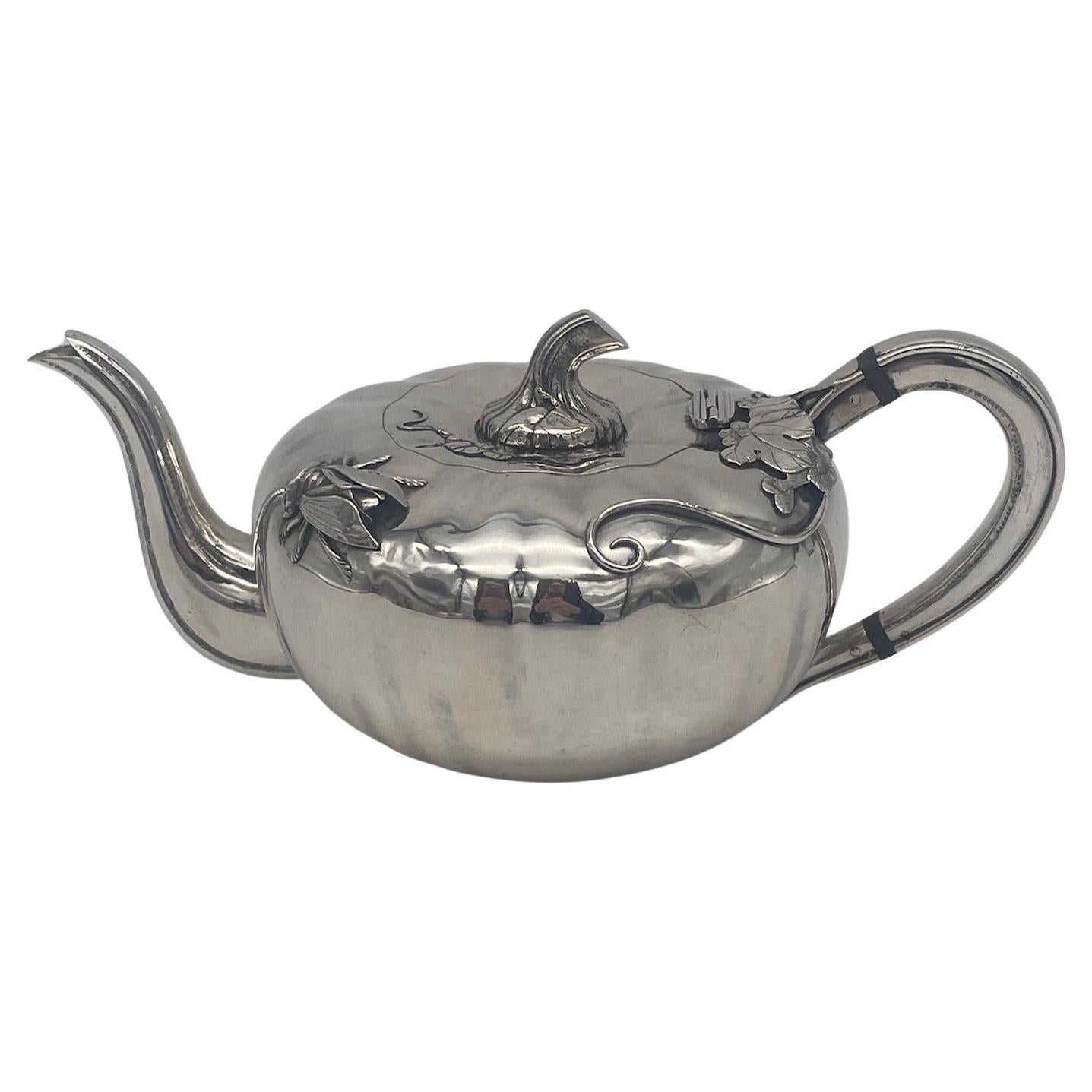 Chinese Export Silver 3-piece Teaset, circa 1920, of pumpkin form, decorated with pumpkin vine and leaves on each piece, and a large impressive cicada on the teapot. The finial on the hinged lid of the teapot and also the pull-off lid on the sugar