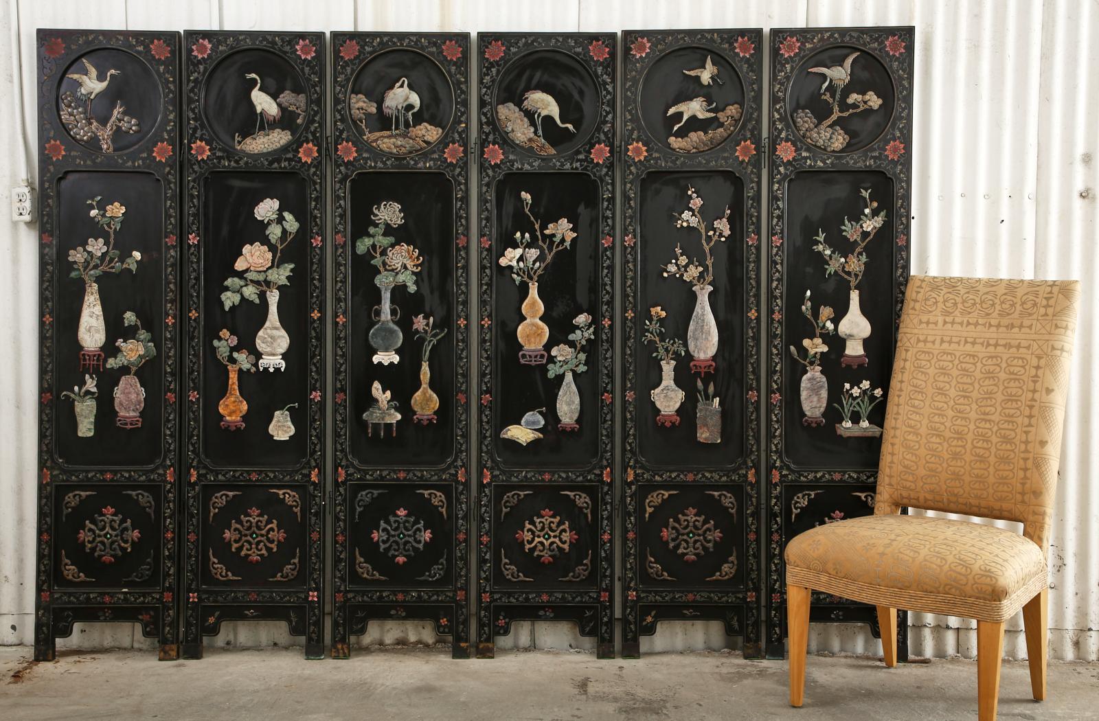 Exceptional Chinese export six-panel lacquered coromandel screen featuring intricately carved hardstone, soapstone, jade, lapis, quartz, and Shoushan stone from Northern Fujian. The panels are decorated with floral and vine scroll work around each