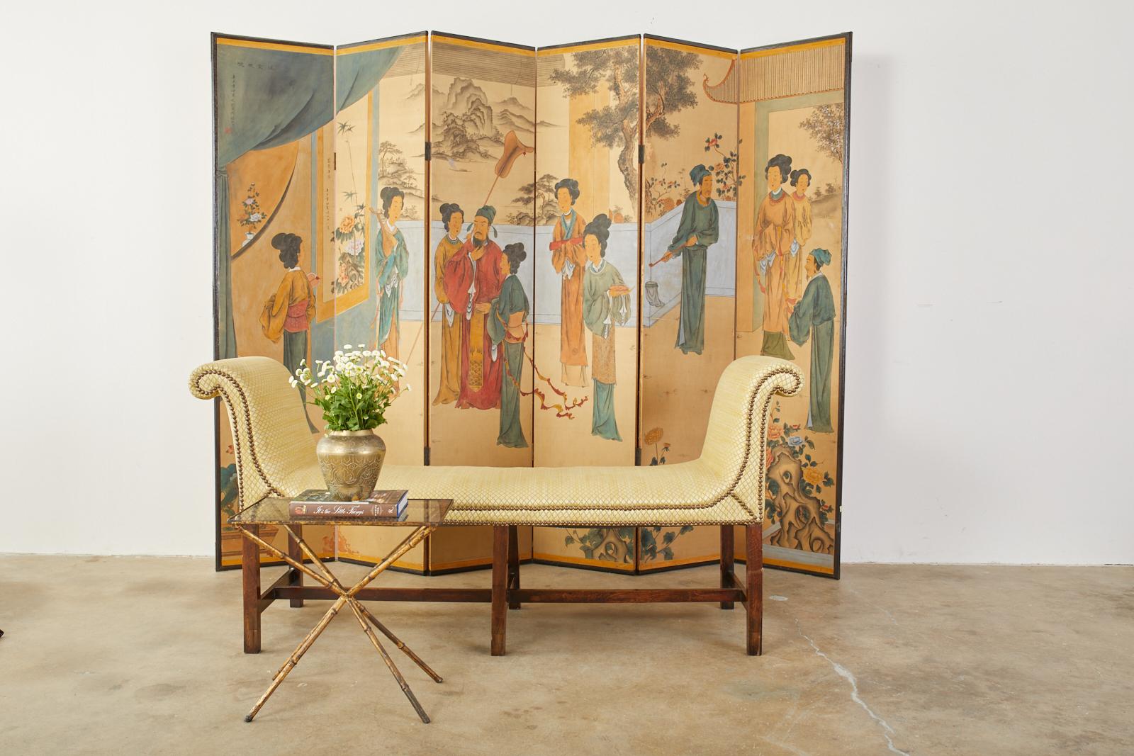 Qing style Chinese export painting featuring figures in a palace garden. Wallpaper scene mounted to a folding six panel screen and set in an ebonized wood frame. Beautiful vibrant colors with a lovely faded patina over a saffron yellow background.