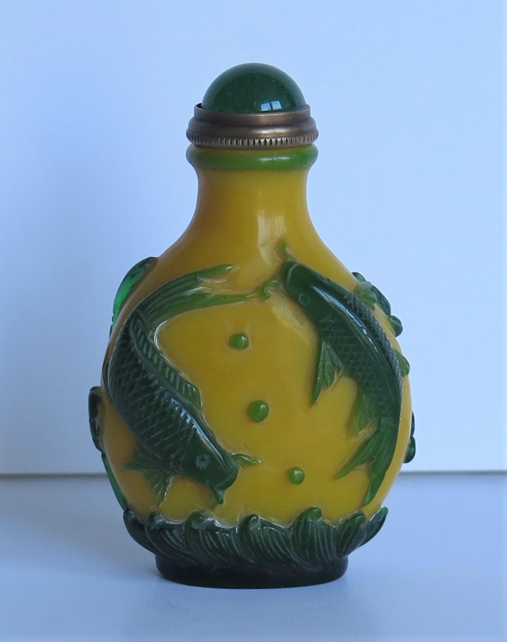 This is a very good Chinese cameo or overlay glass snuff bottle, which we date to circa 1925.

These overlay glass cameo snuff bottles are very decorative and sought after, particularly with this level of excellent carved detail.

It is made of a