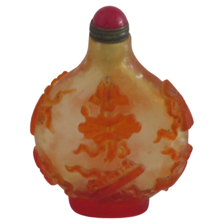 This is a very good Chinese cameo or overlay glass snuff bottle with a spoon top, which we date to circa 1925.

These overlay glass cameo snuff bottles are very decorative and sought after, particularly with two different colour/ shades of