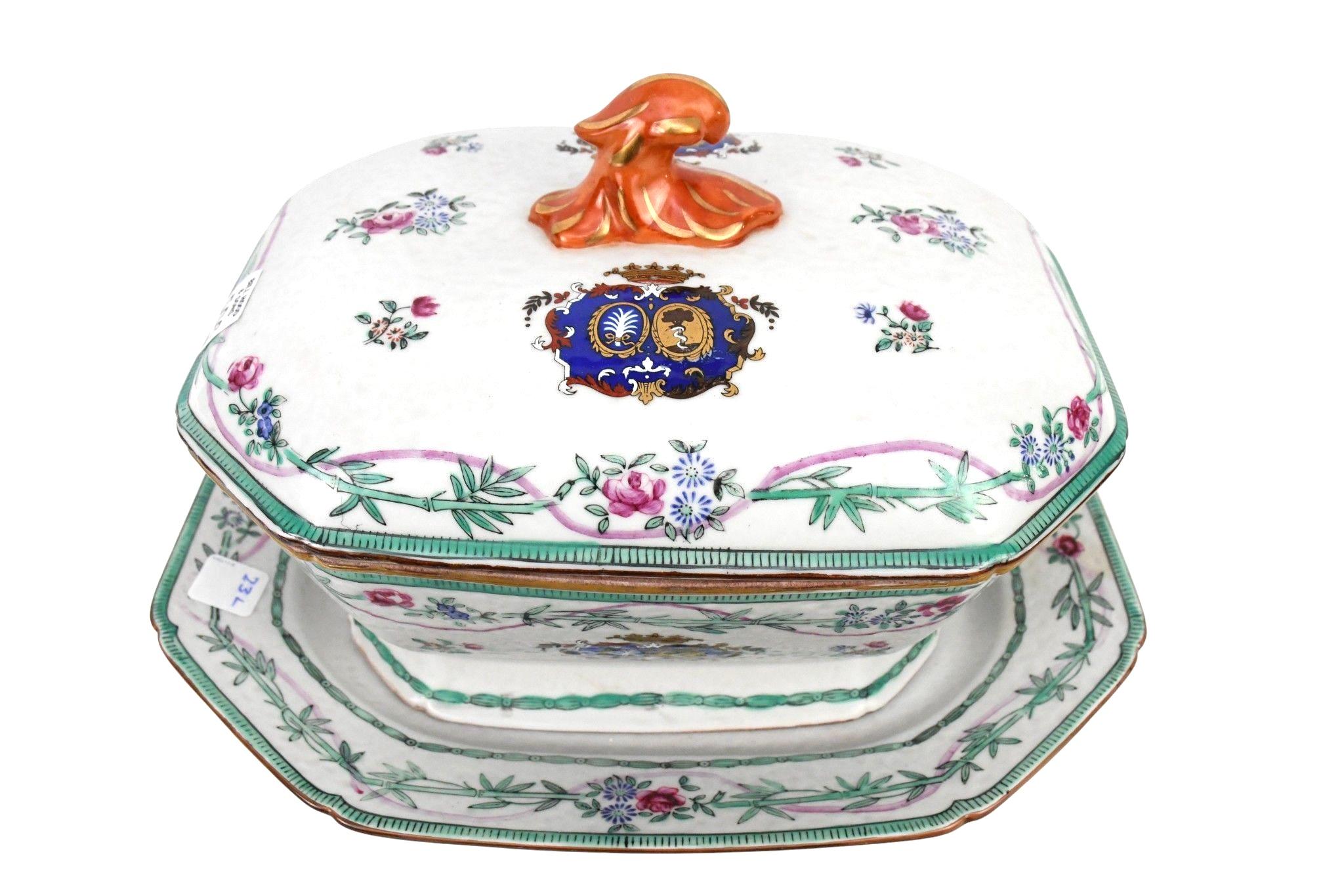 Chinese export Armorial-style Porcelain Soup Tureen. Tureen features rare matching cover and underplate. This elegant piece features double boar-head handles and finely painted floral garlands, bamboo stems, and armorial crest  panels in vibrant