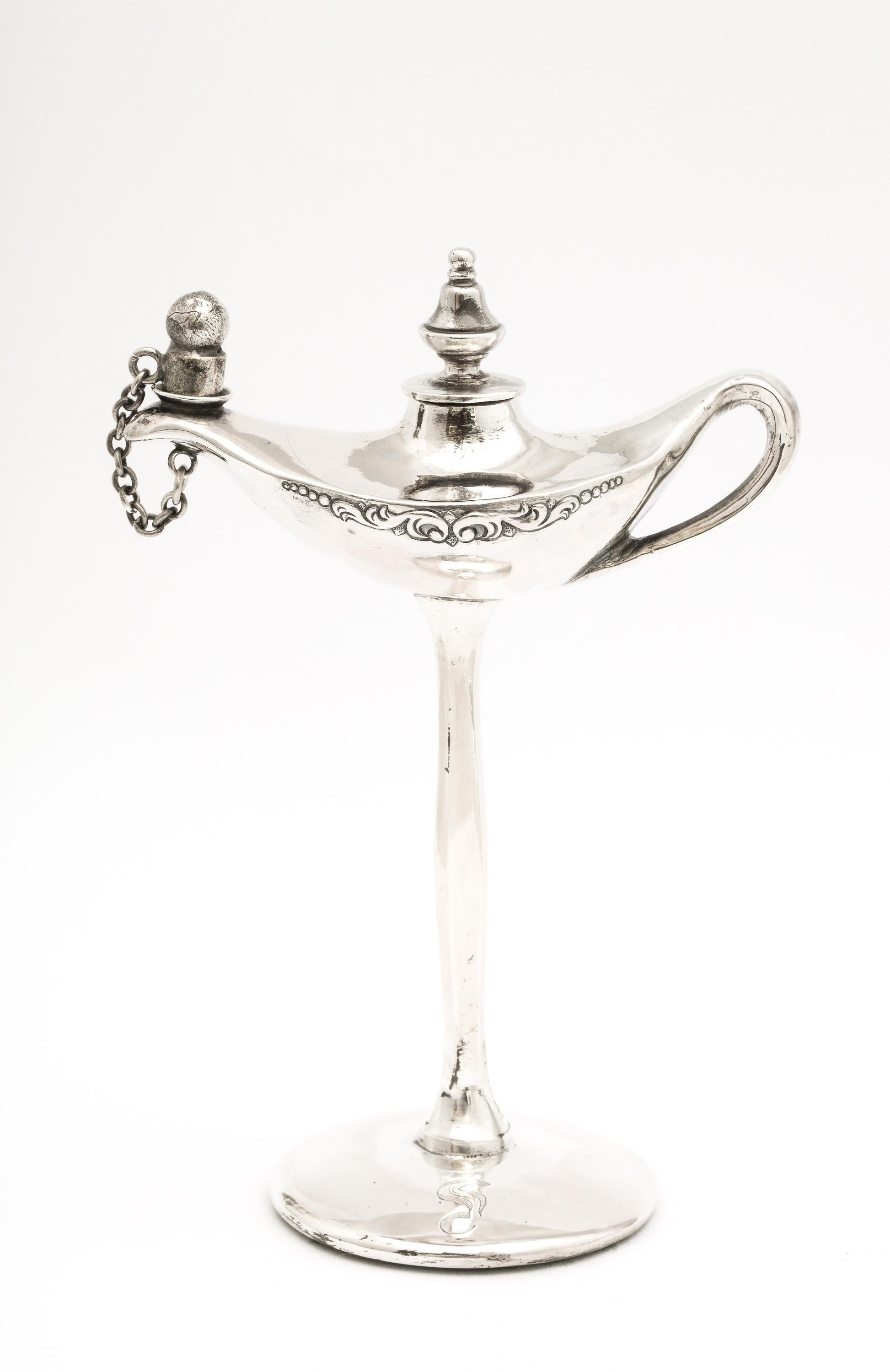 Chinese Export sterling silver Aladdin's lamp - form table lighter on tall pedestal base, China, Ca. 1900. Graceful design. Measures 5 1/4 inches high x 3 1/2 inches wide from outer edge of handle to outed edge of lighter x 2 inches diameter across