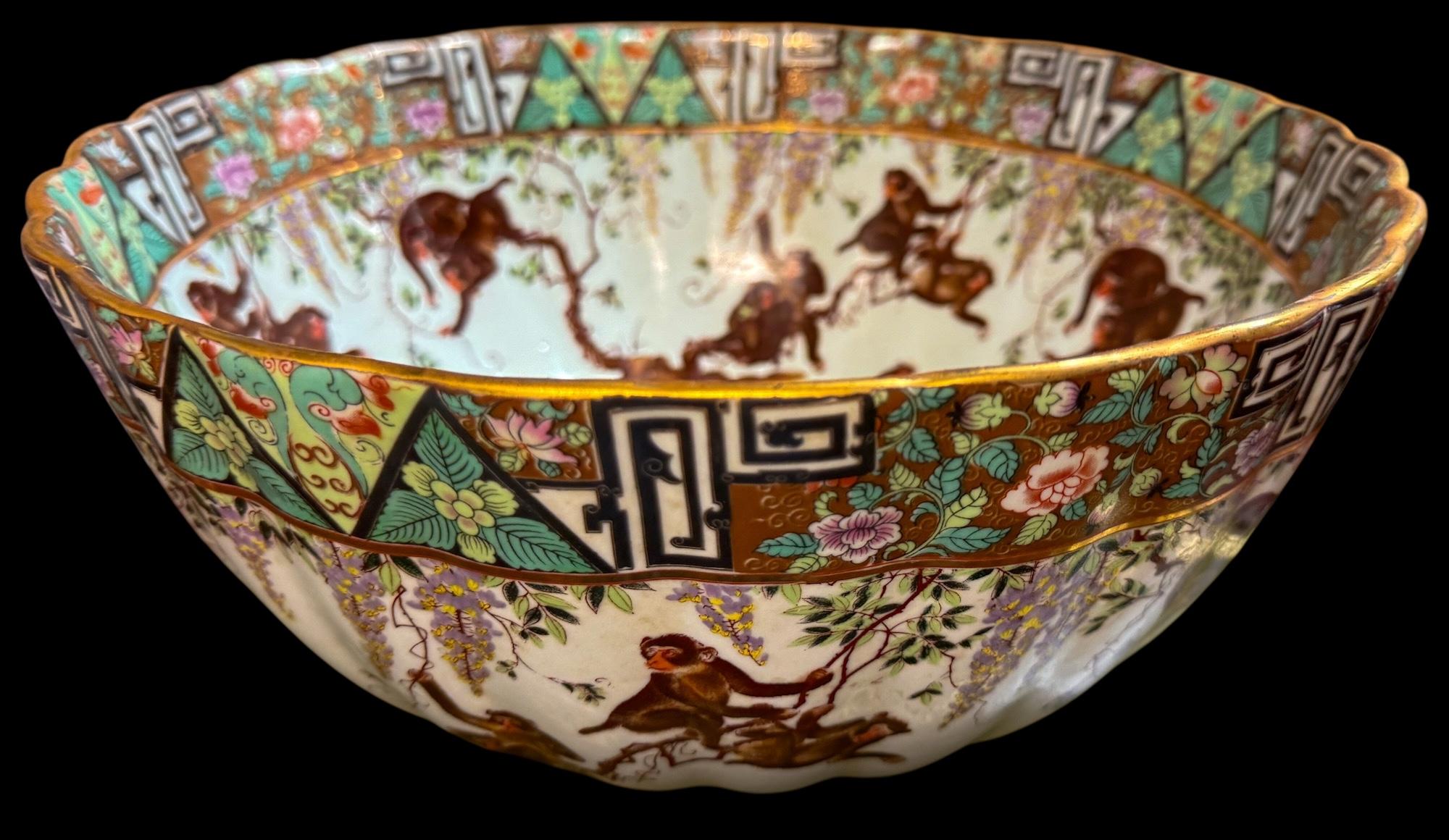 This is a fun large scale Chinese Export center bowl with famille rose paint and playful monkeys circling the inside and out. The measurements do not include the wooden base. Minor age wear.