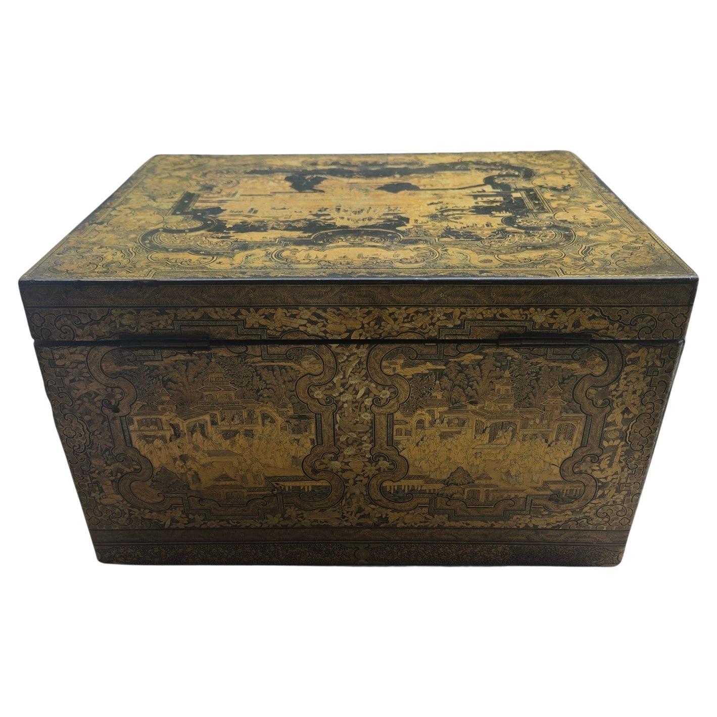 This is a rare early 19th-century (c.1820) Chinese antique large lacquered gilt tea chest, containing an original pewter  tea caddy liner. The chest is beautifully decorated with village scenes and side handles. All hand-painted with gilding in fine