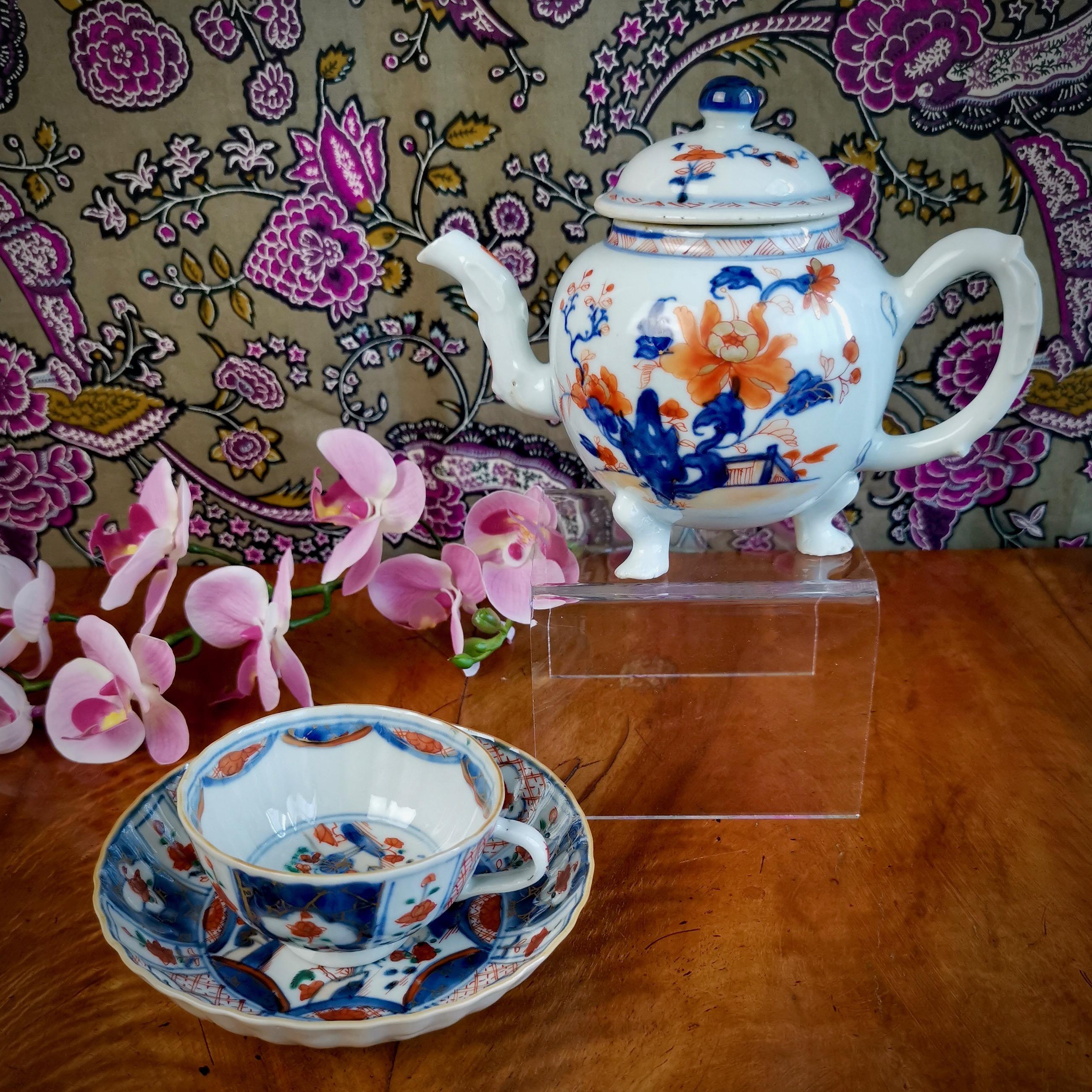 This is a beautiful little teapot made in China for export to the West in the Qianlong period, circa 1750.

The teapot is potted in thick greyish porcelain with shiny glaze, and was decorated with beautiful Japanese-style imari peonies in