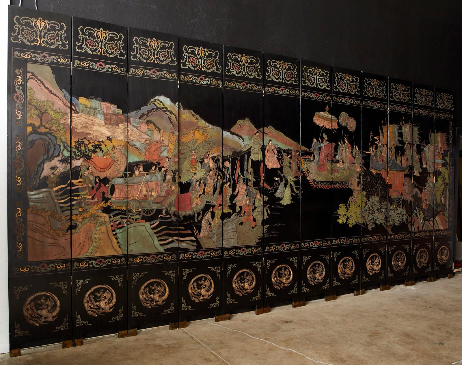 Monumental Chinese export twelve-panel lacquered Coromandel screen of Chinese mythological Daoist character Xiwangmu (Queen mother of the west). Remarkable screen full of vibrant color incised lacquer panels. The scene depicts an entourage of