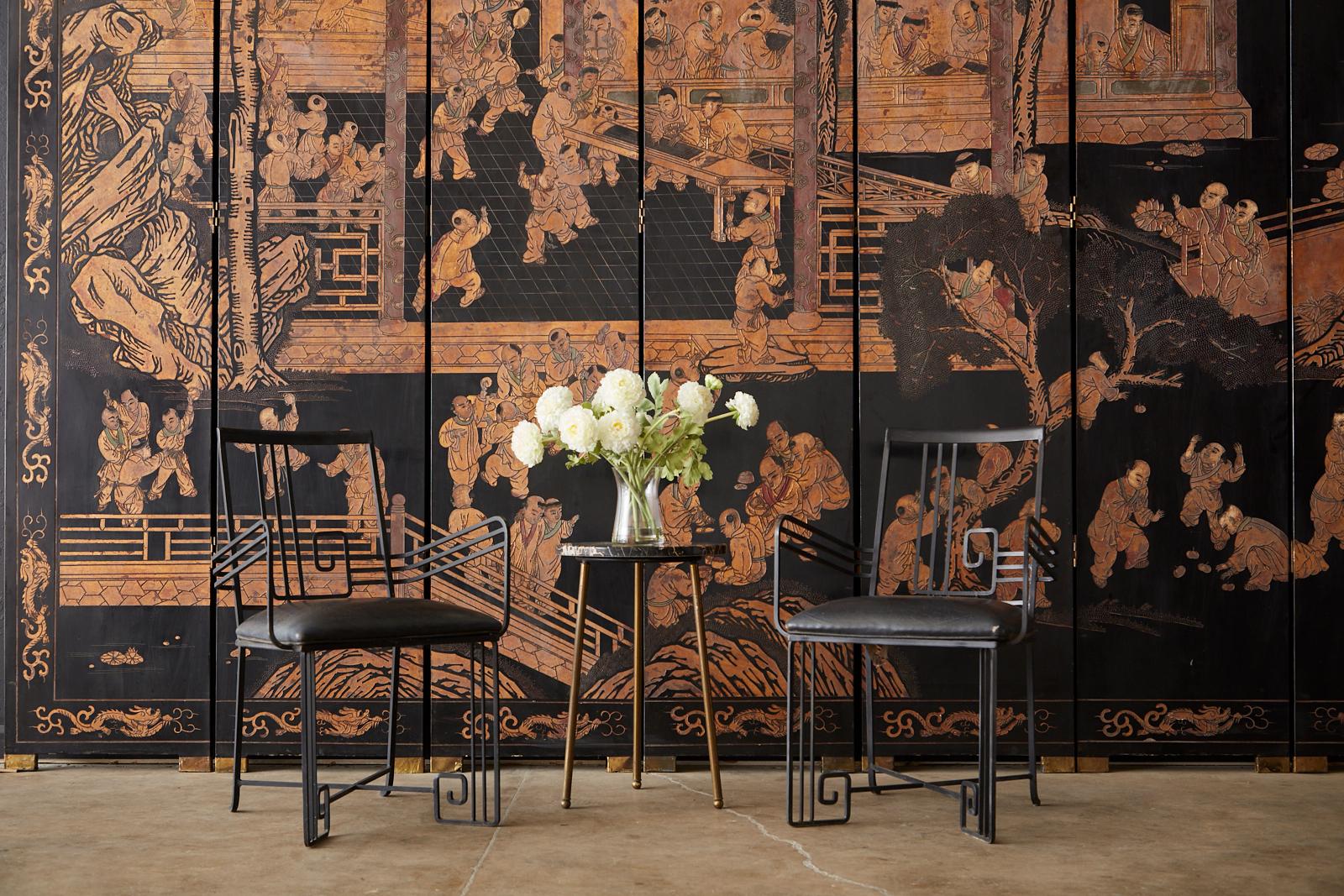 Stunning monumental Chinese export twelve-panel gilt Coromandel screen. Featuring an intricately relief carved black lacquered background depicting one hundred boys in a courtyard playing at leisurely activities. The beautifully incised panels are