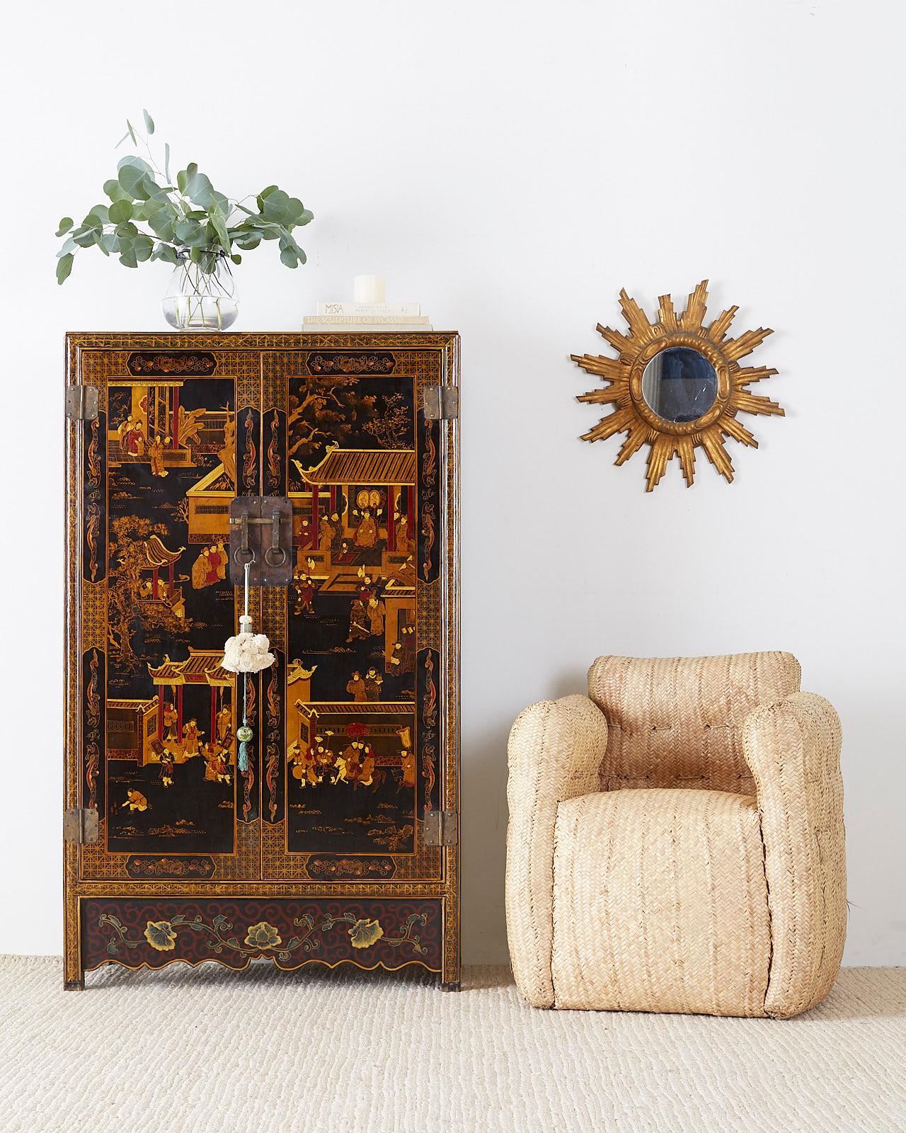 Distinctive Chinese export two-door lacquered cabinet decorated in a wedding style. Features a courtyard scene on the front doors with festive figures among pagodas. The sides and bottom are decorated with flora and fauna motifs. The interior has