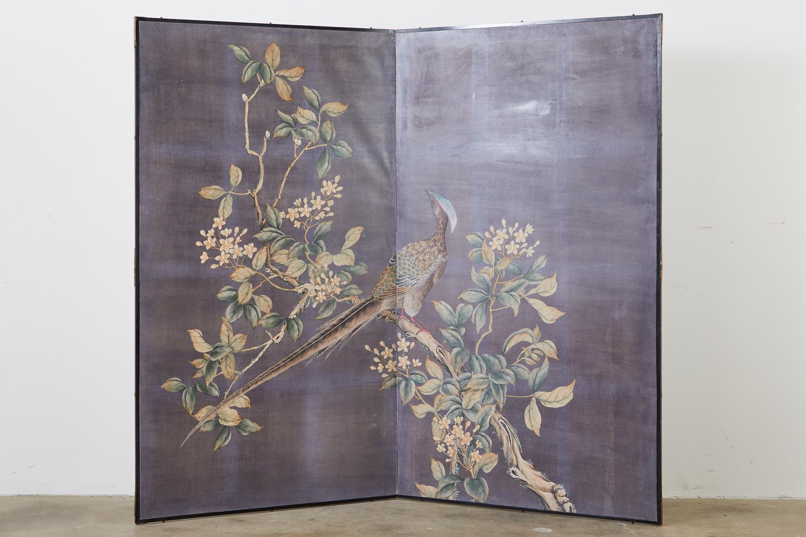 Dramatic Chinese export two-panel screen featuring hand painted wallpaper panels in the style and manner of Gracie chinoiserie paintings. The scene depicts a large pheasant perched in a blossoming dogwood tree with flowers. Ink and natural color