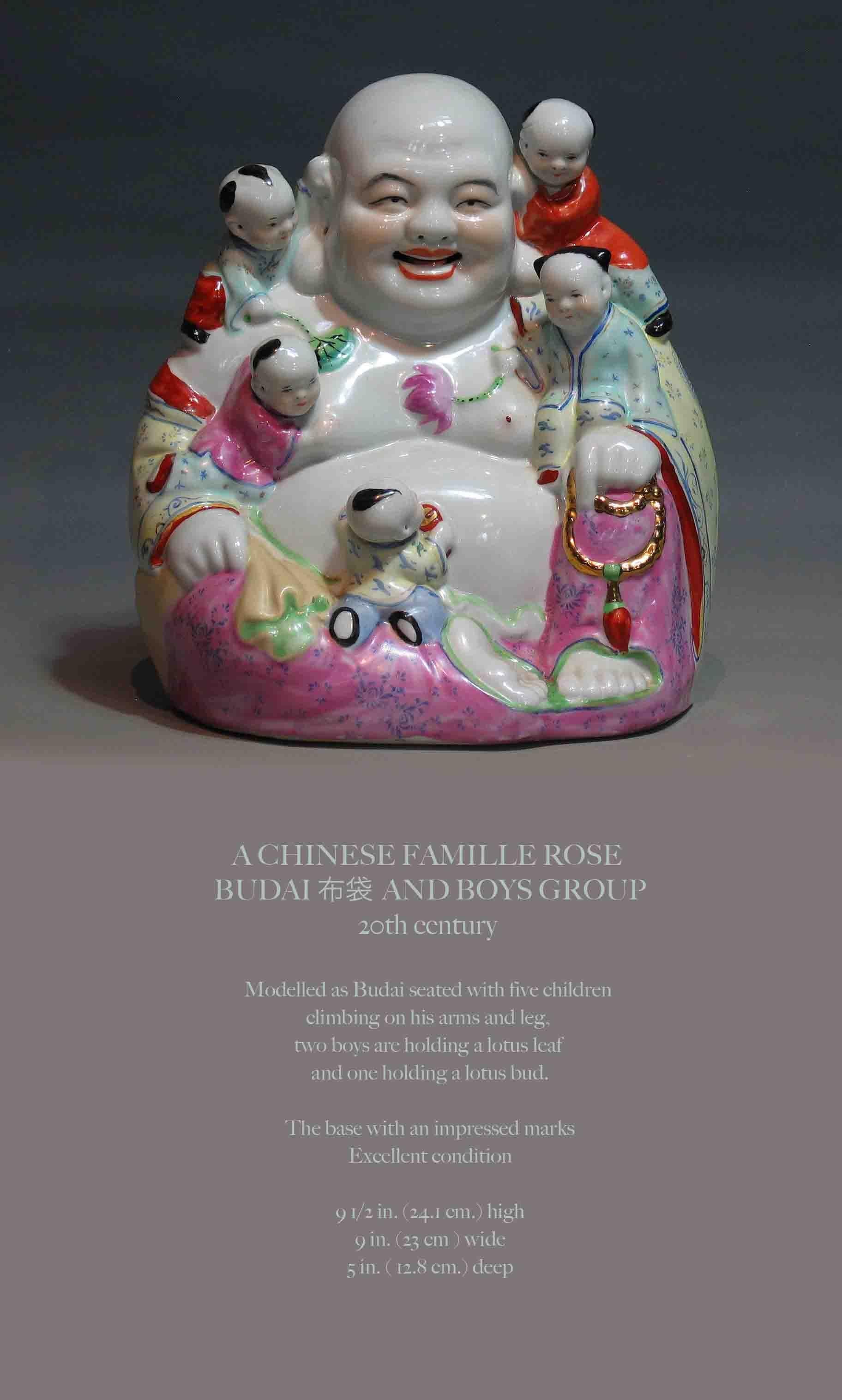 A CHINESE FAMILLE ROSE BUDDHA 
BUDAI ?? AND BOYS GROUP
20th century 

Modelled as Budai seated with five children 
climbing on his arms and leg, 
two boys are holding a lotus leaf 
and one holding a lotus bud.

The base with an impressed