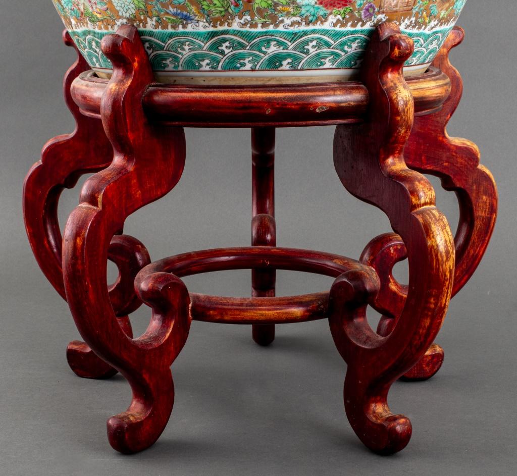 Pair of Chinese Famille Rose Ceramic Jardinieres, hand-painted with polychrome dragons on a gilt ground above a wave border, with wood stands.

Dealer: S138XX