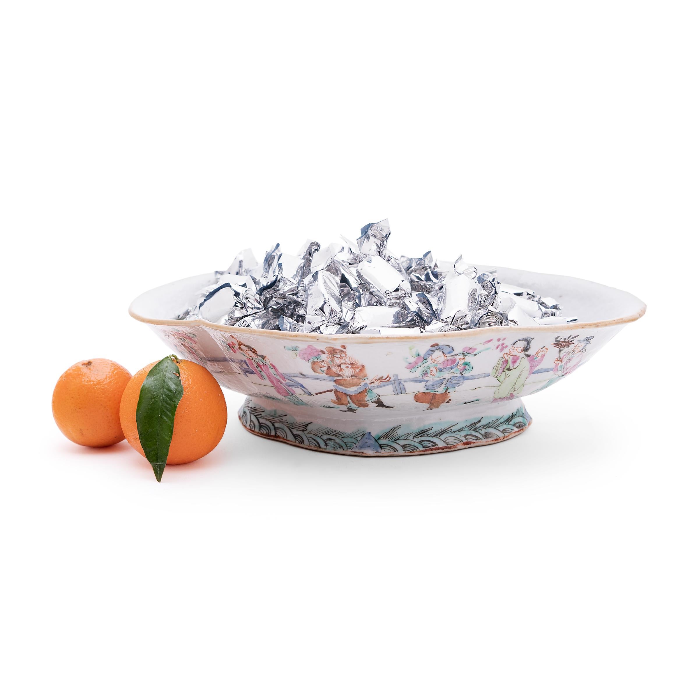 This colorful porcelain bowl dates to the mid-19th century and was originally used as a serving dish for ritual offerings, placed before a home altar and piled high with fruit, baked goods, and other foods. The cartouche-shaped dish features a short