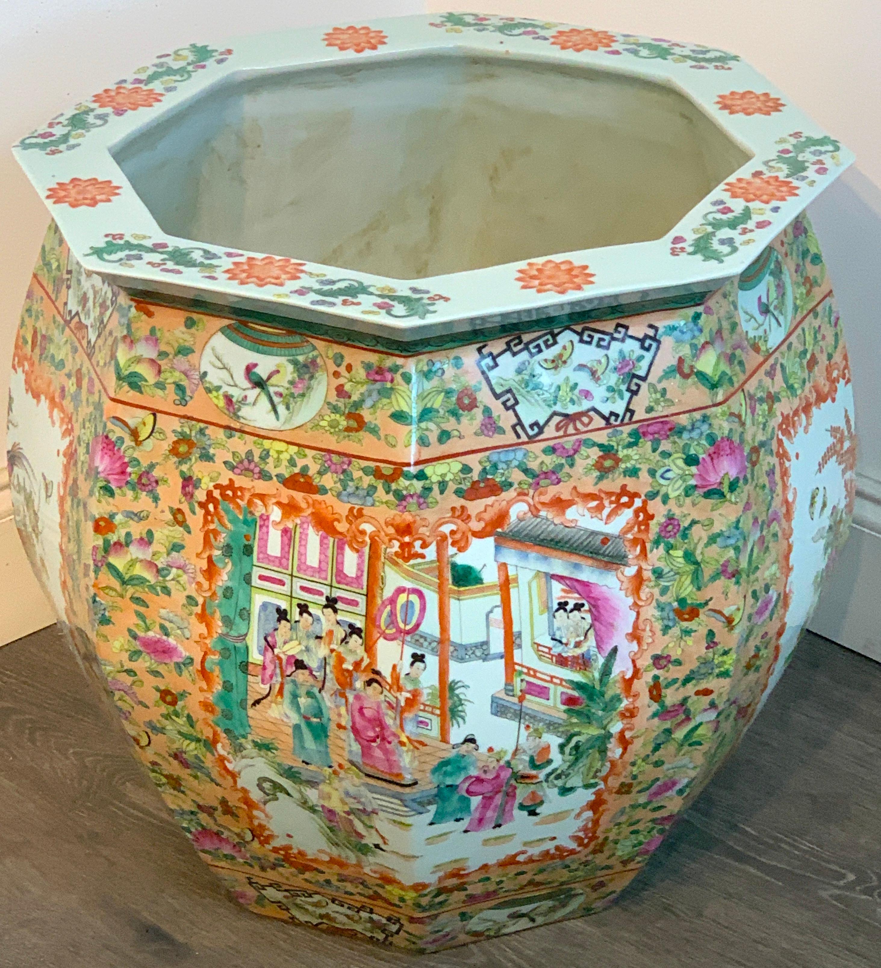 Chinese famille rose octagonal fish bowl/ jardinière, of large scale, beautifully painted with court scenes and floral vignettes. The interior diameter is 15