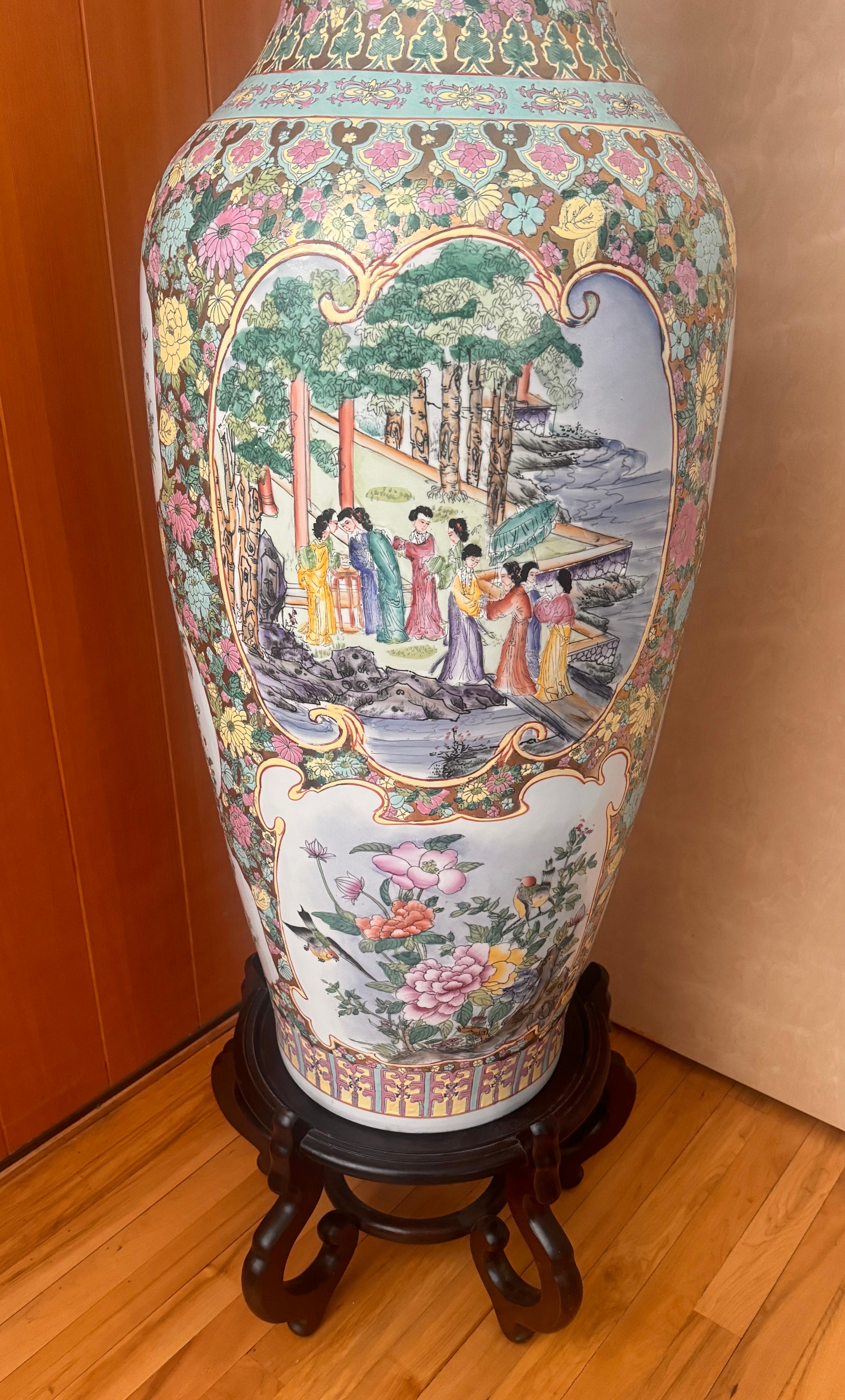 This large Chinese Famille Rose porcelain vase features a beautiful multi color design. The vase is adorned with intricate figurative patterns, showcasing traditional Chinese artistry. Made of high-quality porcelain, this glossy finished vase is a