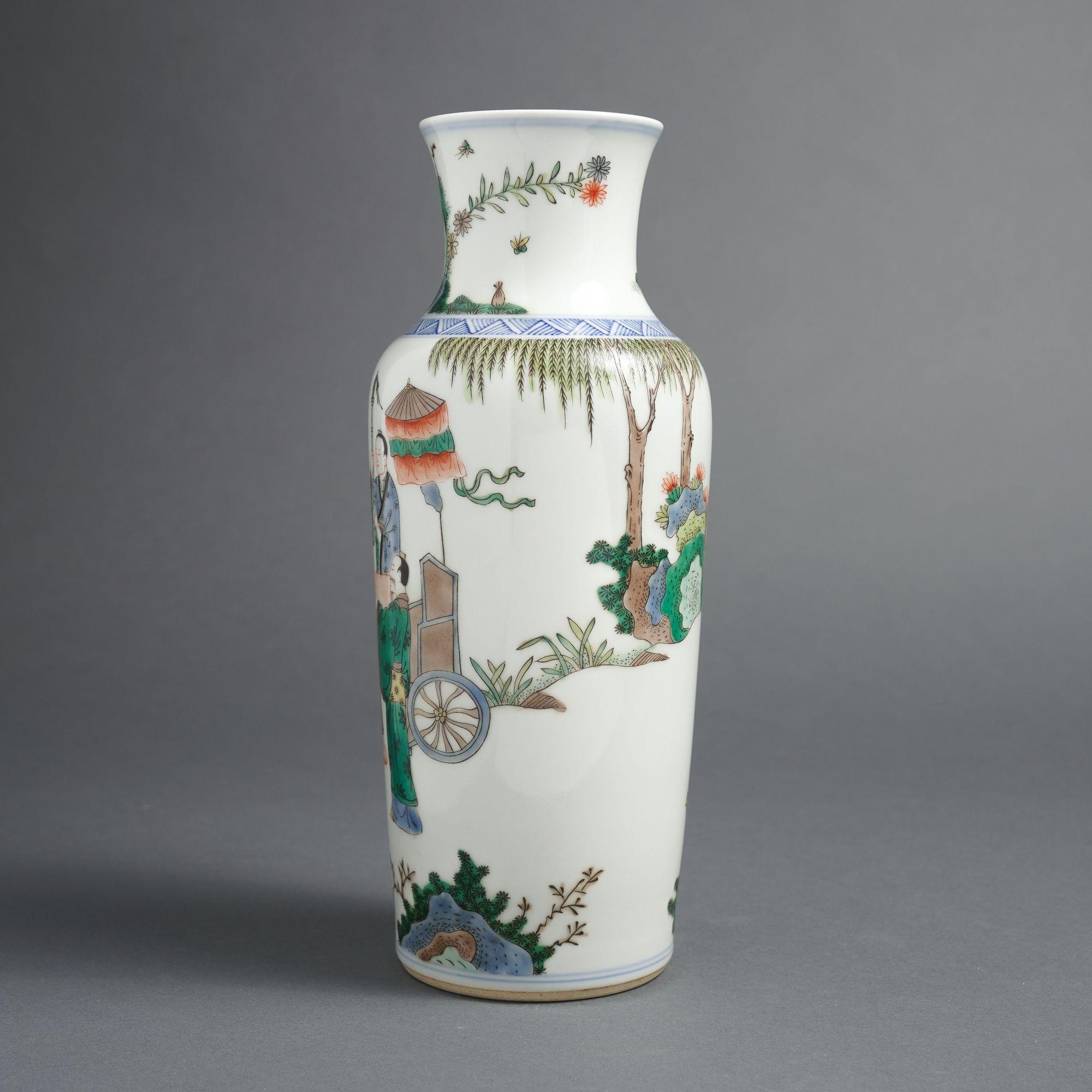 Chinese Famille Verte porcelain sleeve form rouleau vase with six figure mark encircled in double rings in cobalt underglaze blue on the underfoot. The vase is decorated in a continuous scene of figures in a garden landscape, dressed in garments
