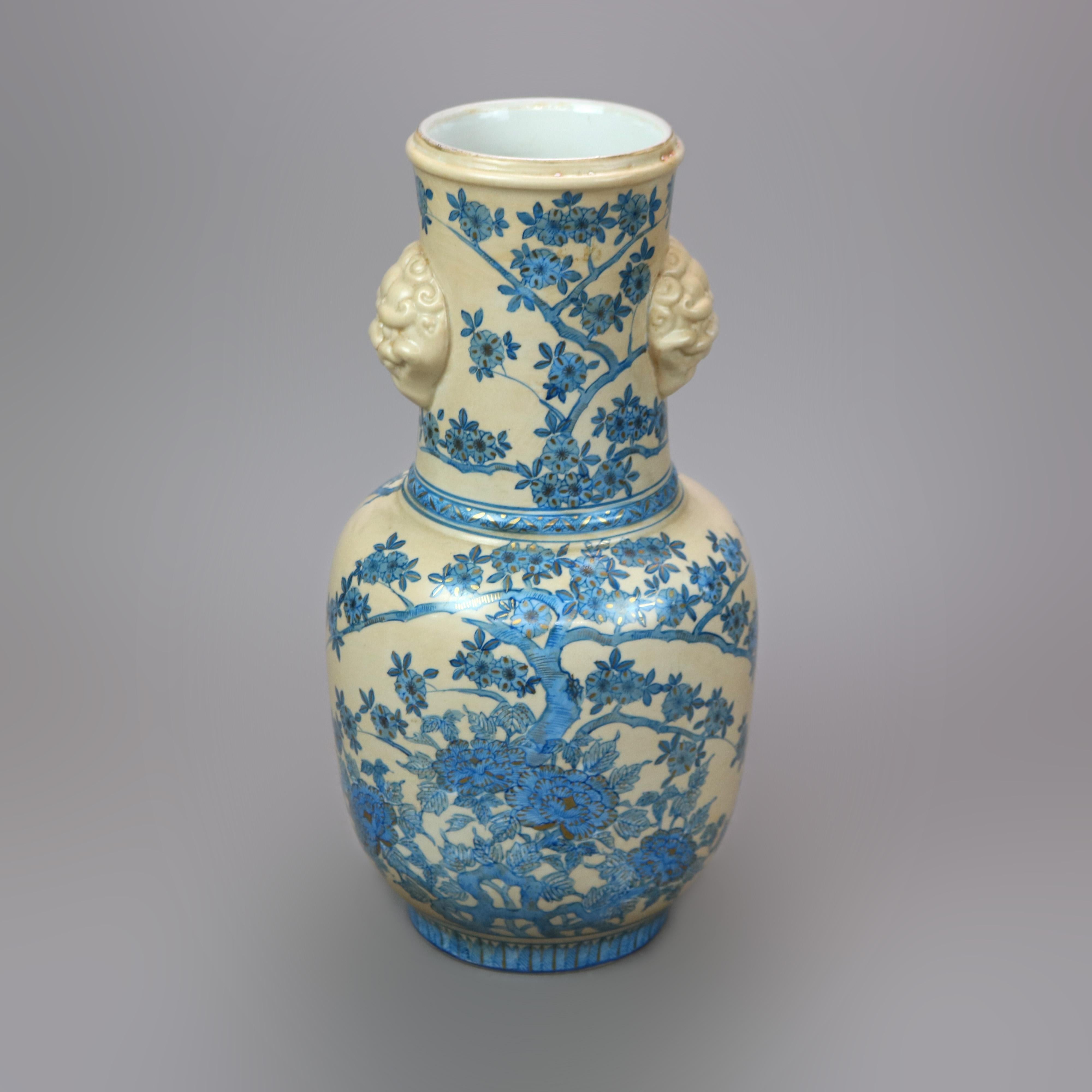 A Chinese figural vase offers porcelain construction in bulbous form having foo dog mask double handles over hand painted vessel with garden design, gilt highlights throughout, 20th century

Measures - 17.5'' H x 8.5'' W x 8.5'' D.

Catalogue Note:
