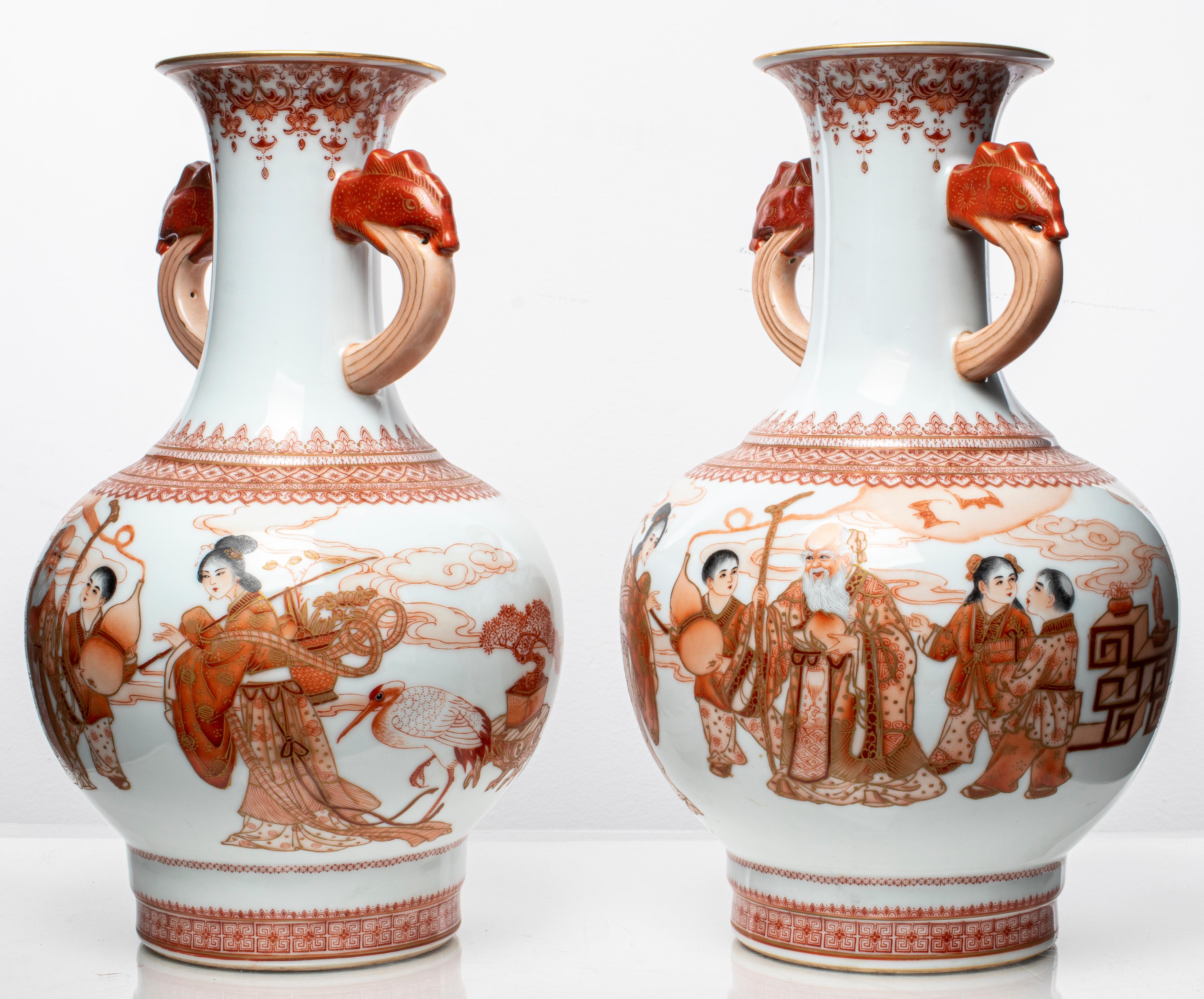 Pair of Chinese porcelain vases with double dragon handles and figural motif decoration, depicting scenes with elder and youth, signed underside. 13