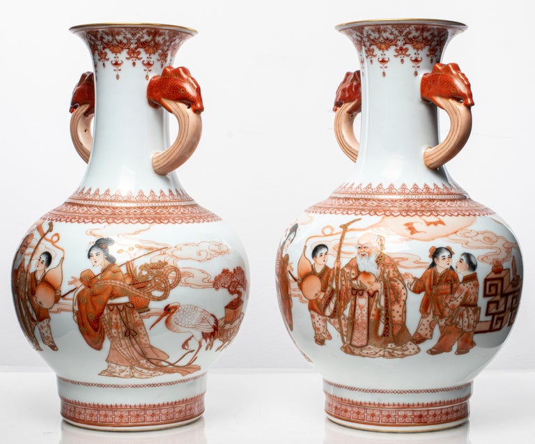 Pair of Chinese porcelain vases with double dragon handles and figural motif decoration, depicting scenes with elder and youth, signed underside. 13