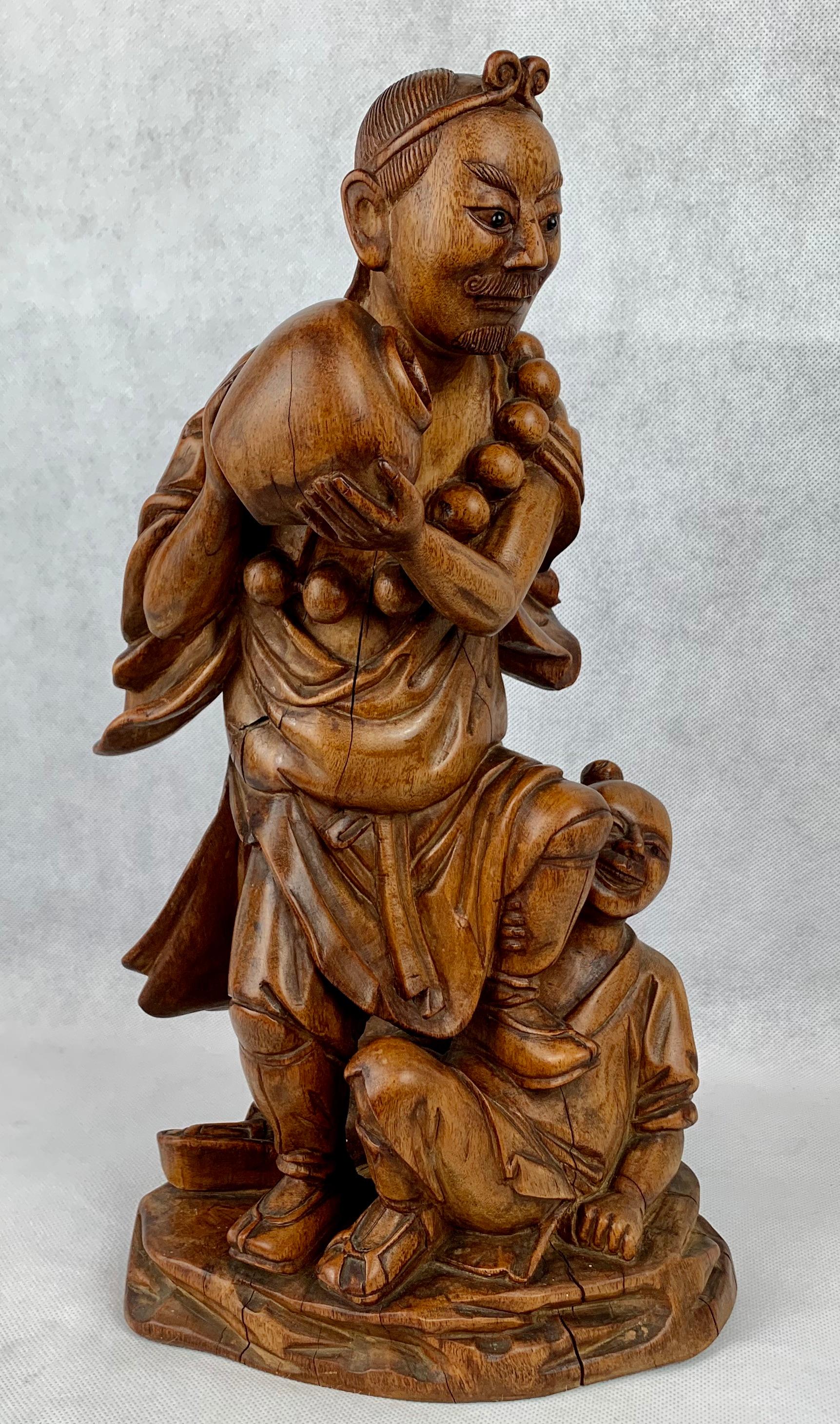 The Chinese teak carving of a male water bearer with a boy at his feet.
Due to age there are some splits, such as the one down the backside.  These do not affect the strength or usability of the figure.
Cleaned and polished by hand in our workshop.