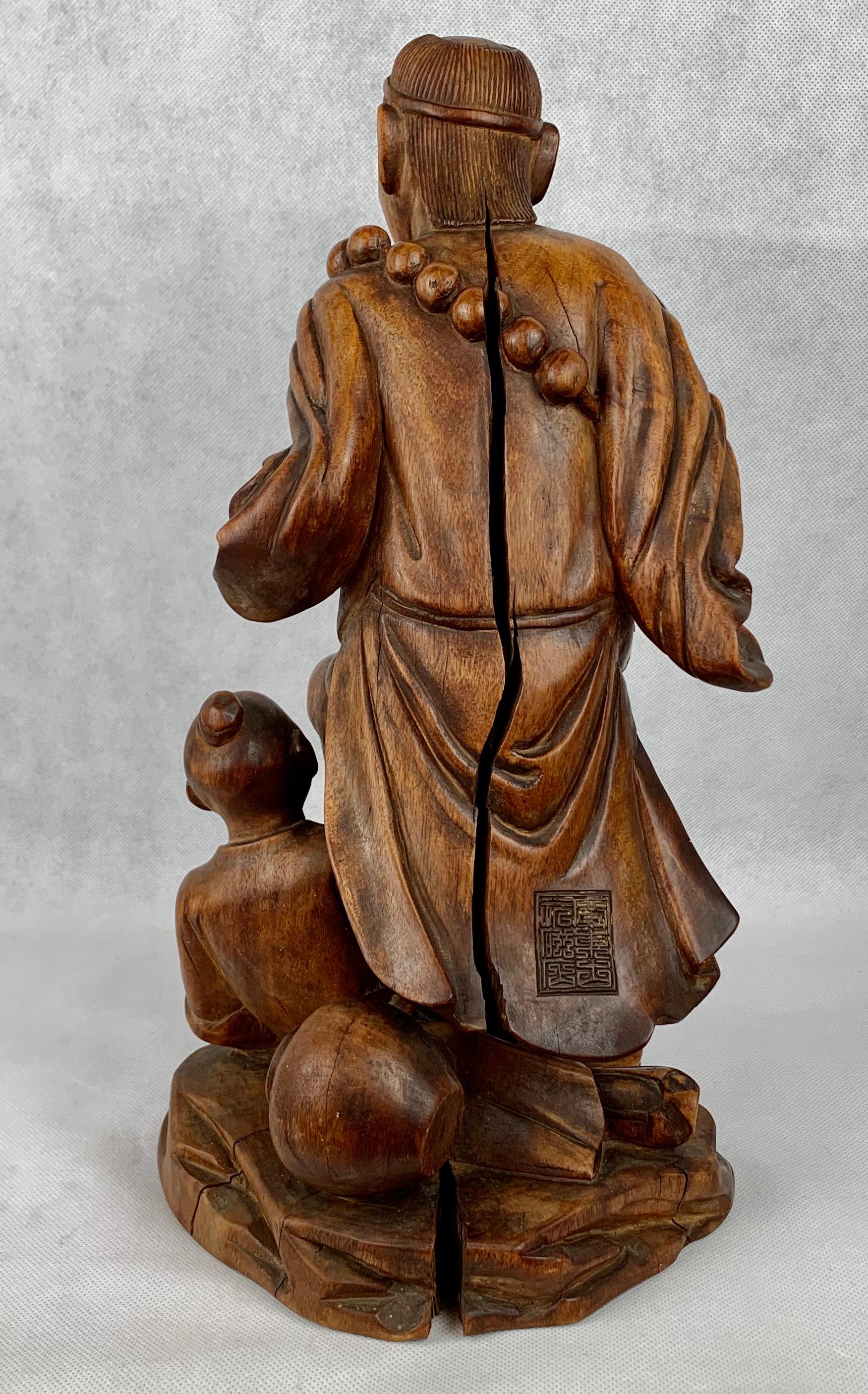 Hand-Carved Hand Carved Teak Chinese Male Figure with Boy For Sale