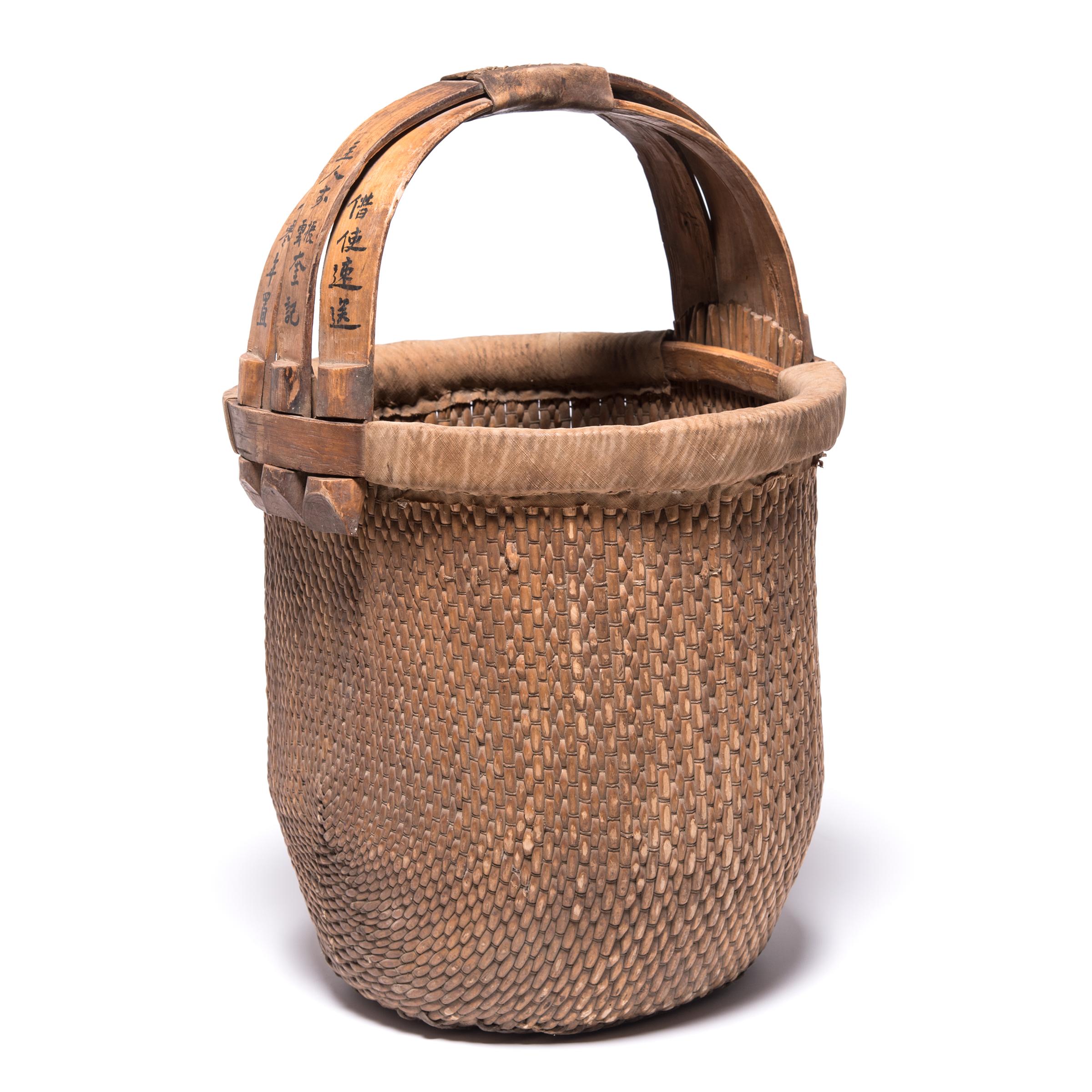 Basket making is an ancient and humble craft, but in the hands of a skilled weaver a simple willow basket becomes a truly beautiful statement. The artisan’s mastery is evident in this early 20th century bent handle basket: the strong, flexible