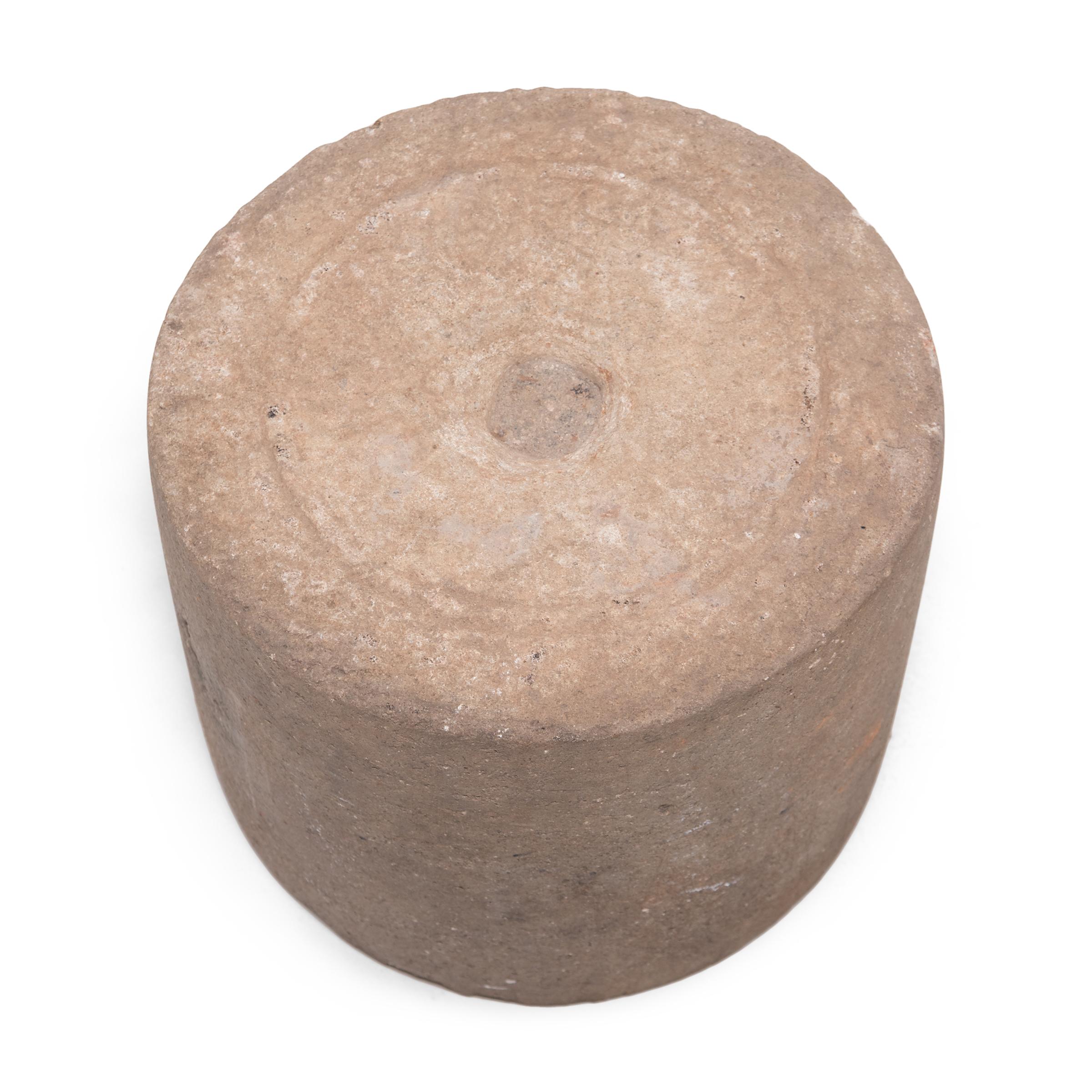 This stone barrel-shaped table is an architectural fragment from the late Qing dynasty and was originally used to anchor a metal flagpole. Despite its functional origins, the anchor has a balanced, linear form and continues a long Chinese tradition