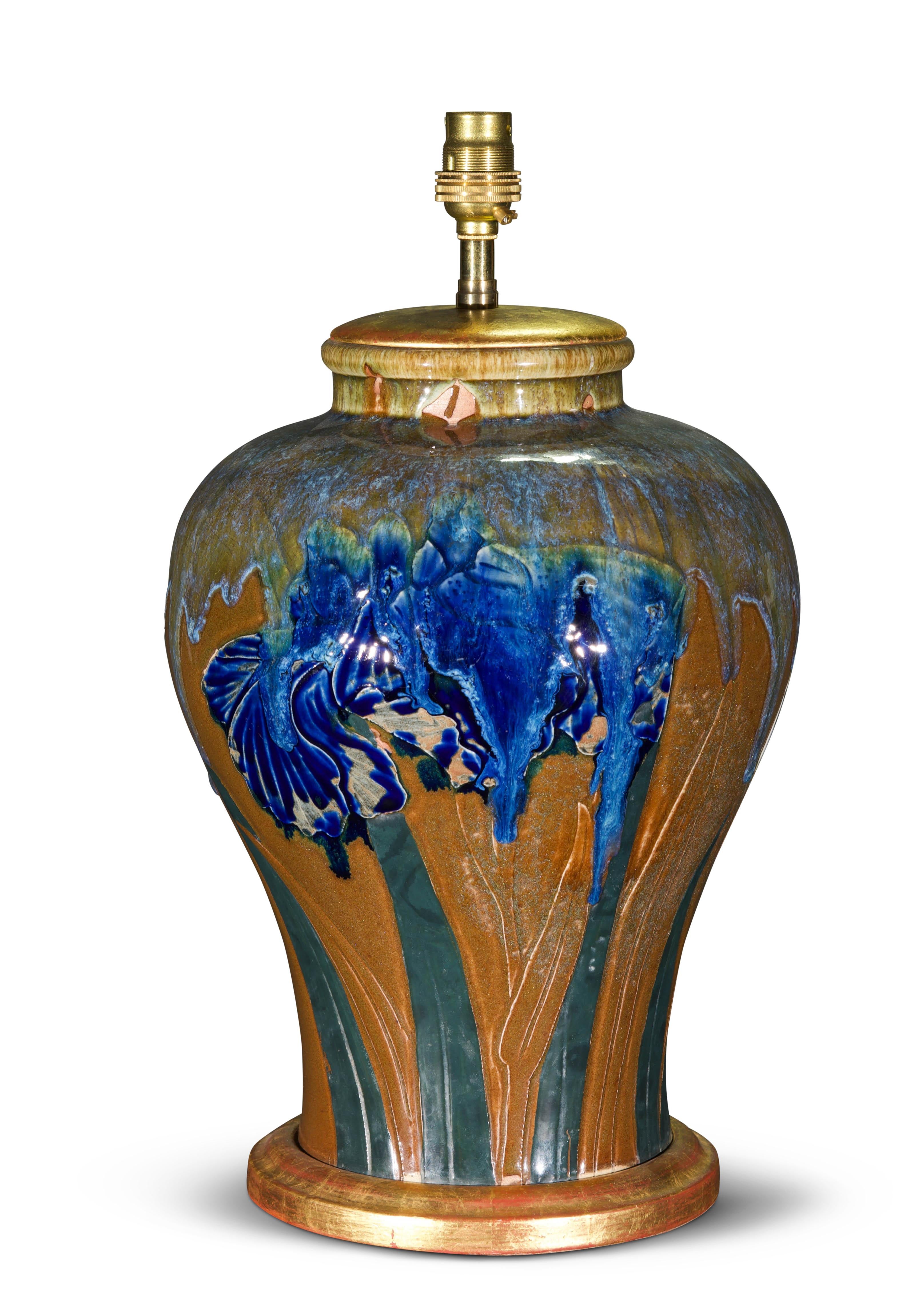 A very charming flambé-glazed vase, decorated with painted irisies, now mounted as a table lamp, with a hand-gilded turned base.

Height of vase: 13 in (33 cm) including giltwood base, excluding electrical fitment and lampshade.

All of our