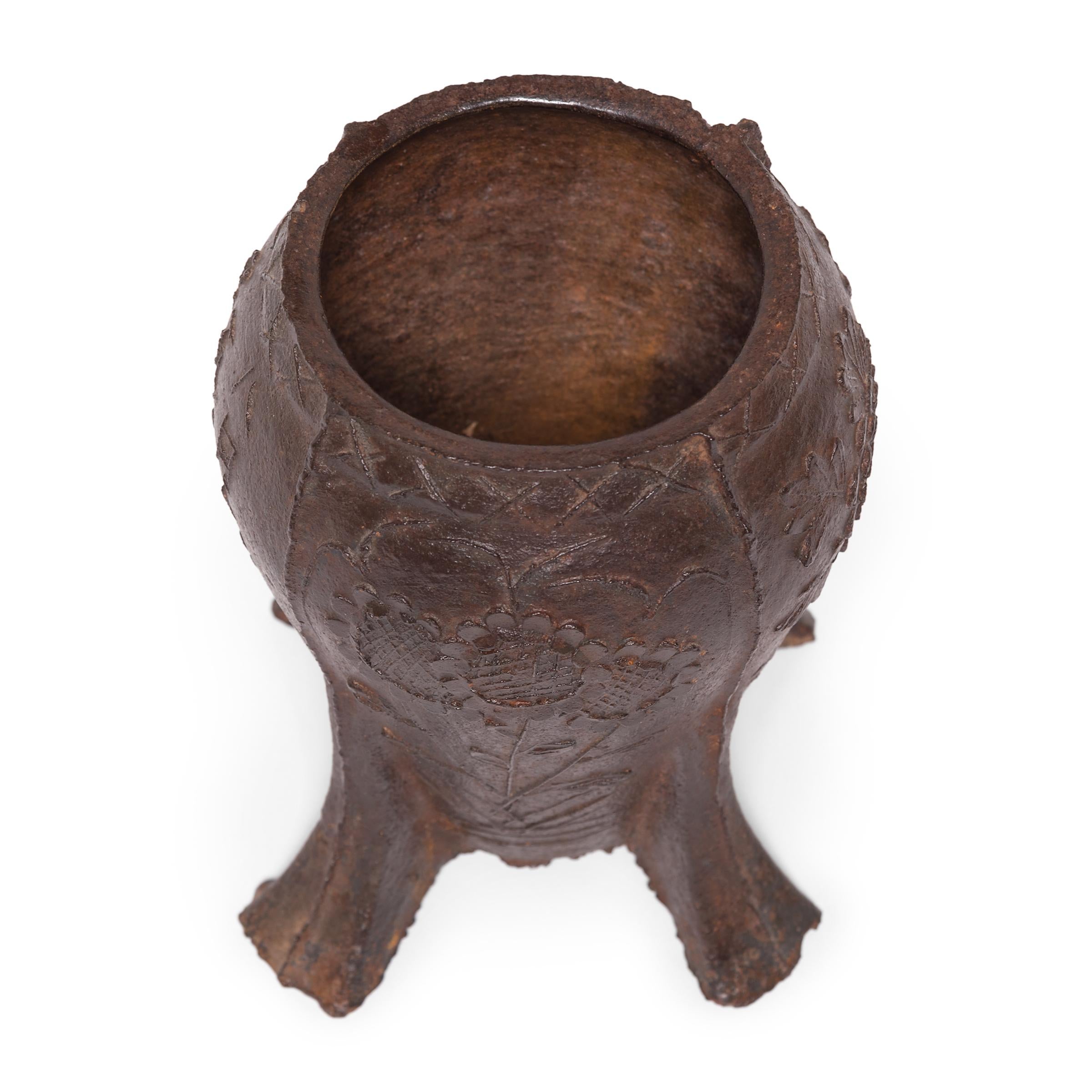Cast in iron with a raised floral design, this vintage mortar was once used in a traditional apothecary to create herbal medicines. Beautifully aged with a rich patina, the footed mortar is perfect as a petite planter or home accent.
