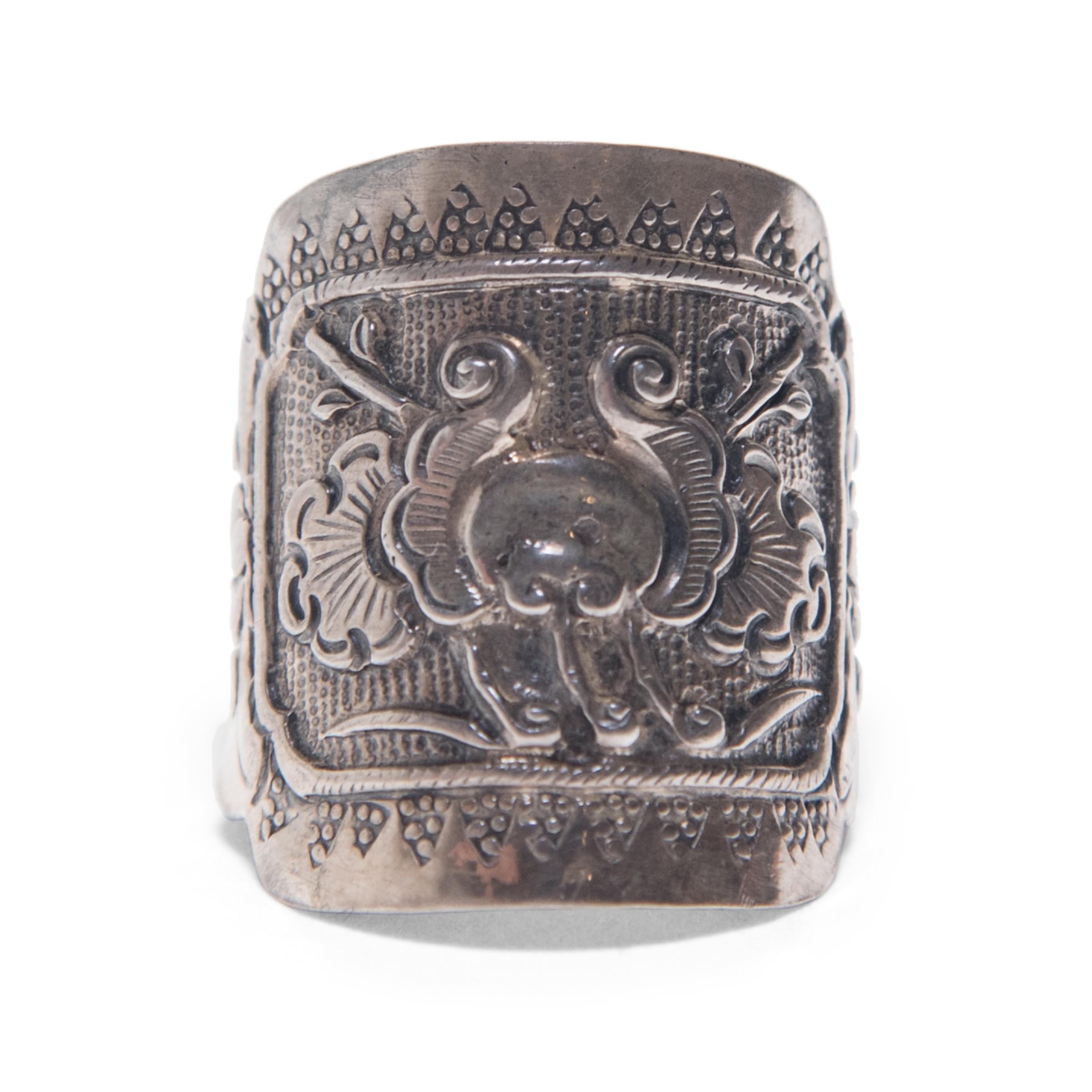 Dated to the late 19th century, this silver charm ring was believed to protect the wearer from bad luck and malevolent spirits. The ring is intricately decorated with geometric patterns and a floral design in low relief.

Ring size is adjustable.