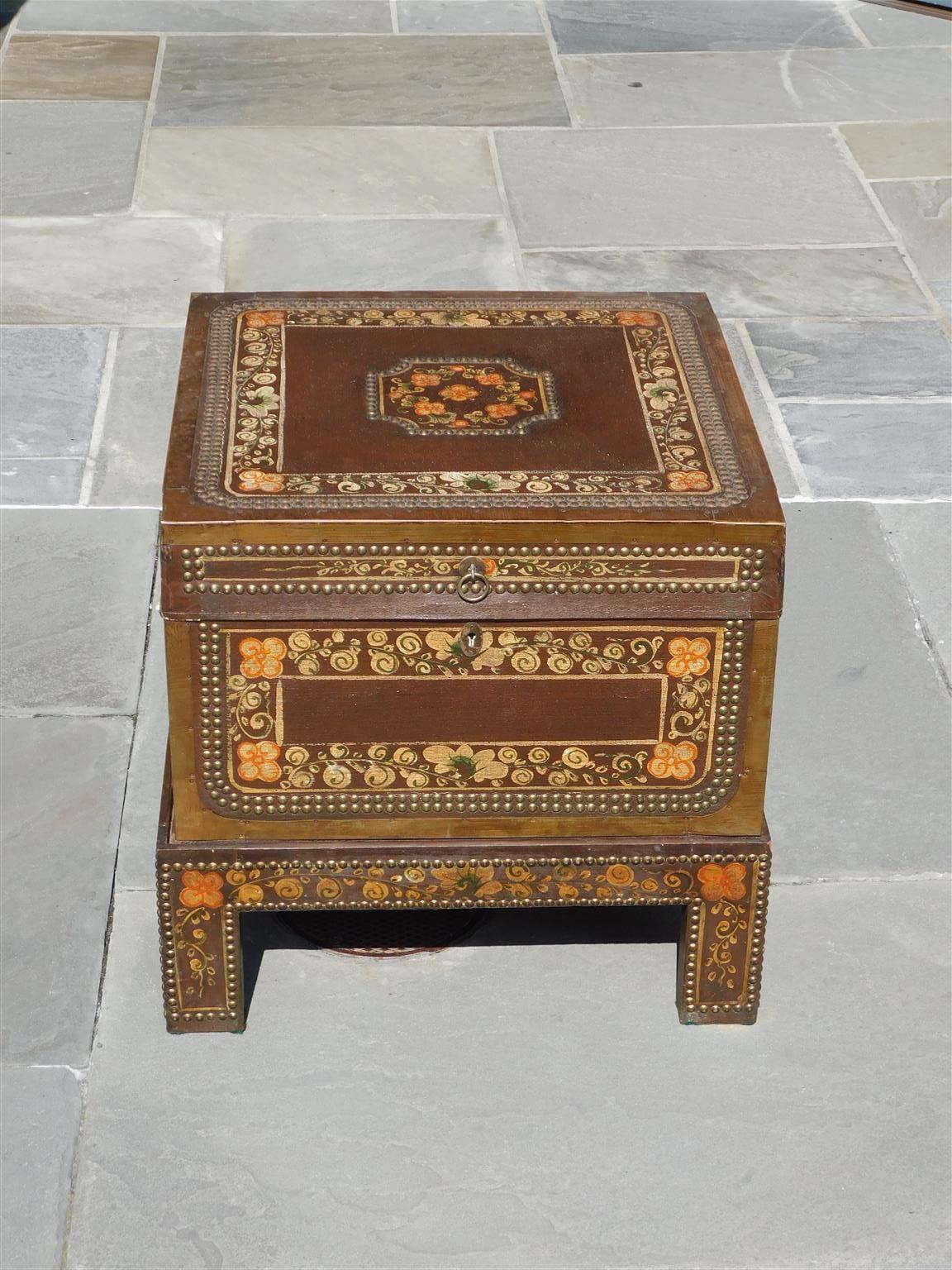 Chinese foliage painted and brass mounted tacked hinged chest on stand with flanking side handles and interior lock with key, Late 19th Century