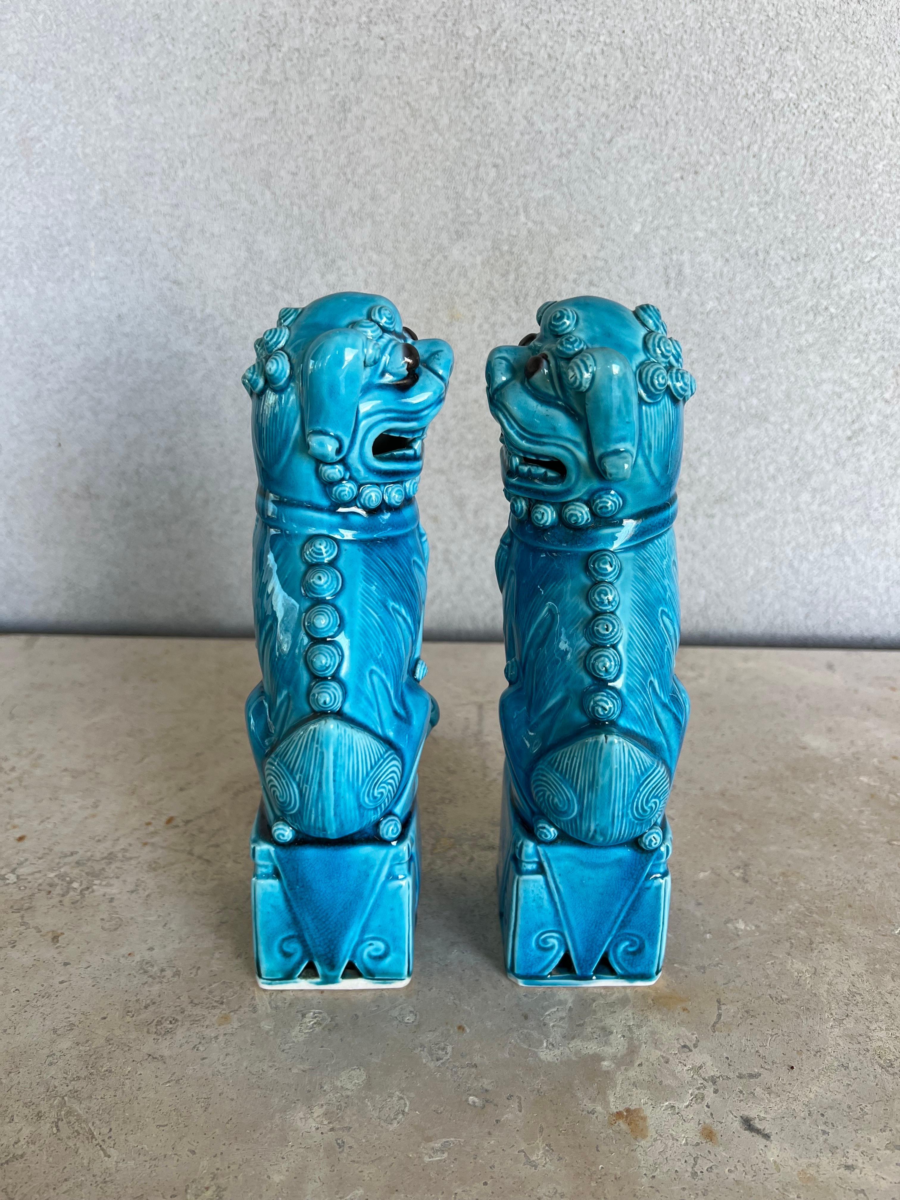 Stunning pair of left and right facing Chinese Foo Dog statues in turquoise glaze, ancient symbols of prosperity, longevity and protection will bring beauty and balance to any decorative arrangement
In perfect condition 
1.75” W x 2.25” L x 9.5” H