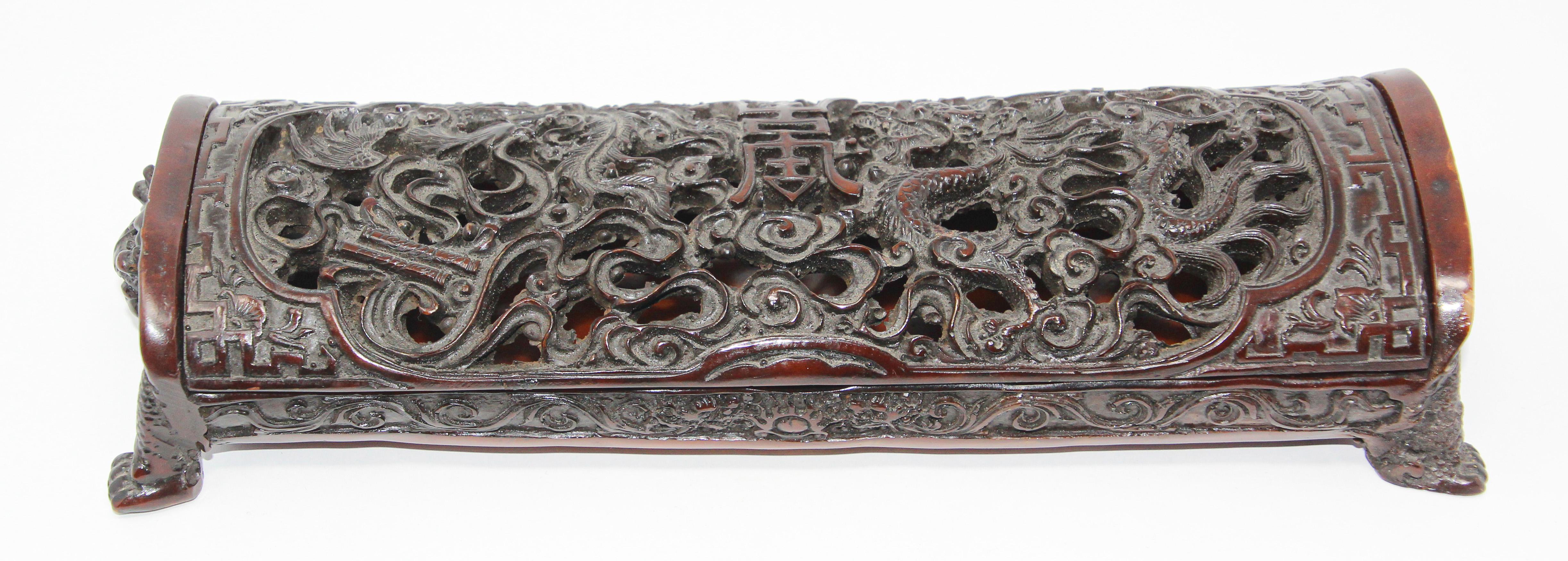 Chinese box with dragon motifs.
The rectangular lidded dragon box is embellished with a fine and impressive design featuring high relief dragon heads on each side.
A very well done Chinese figural art object in dark cast resin composite.
Great to