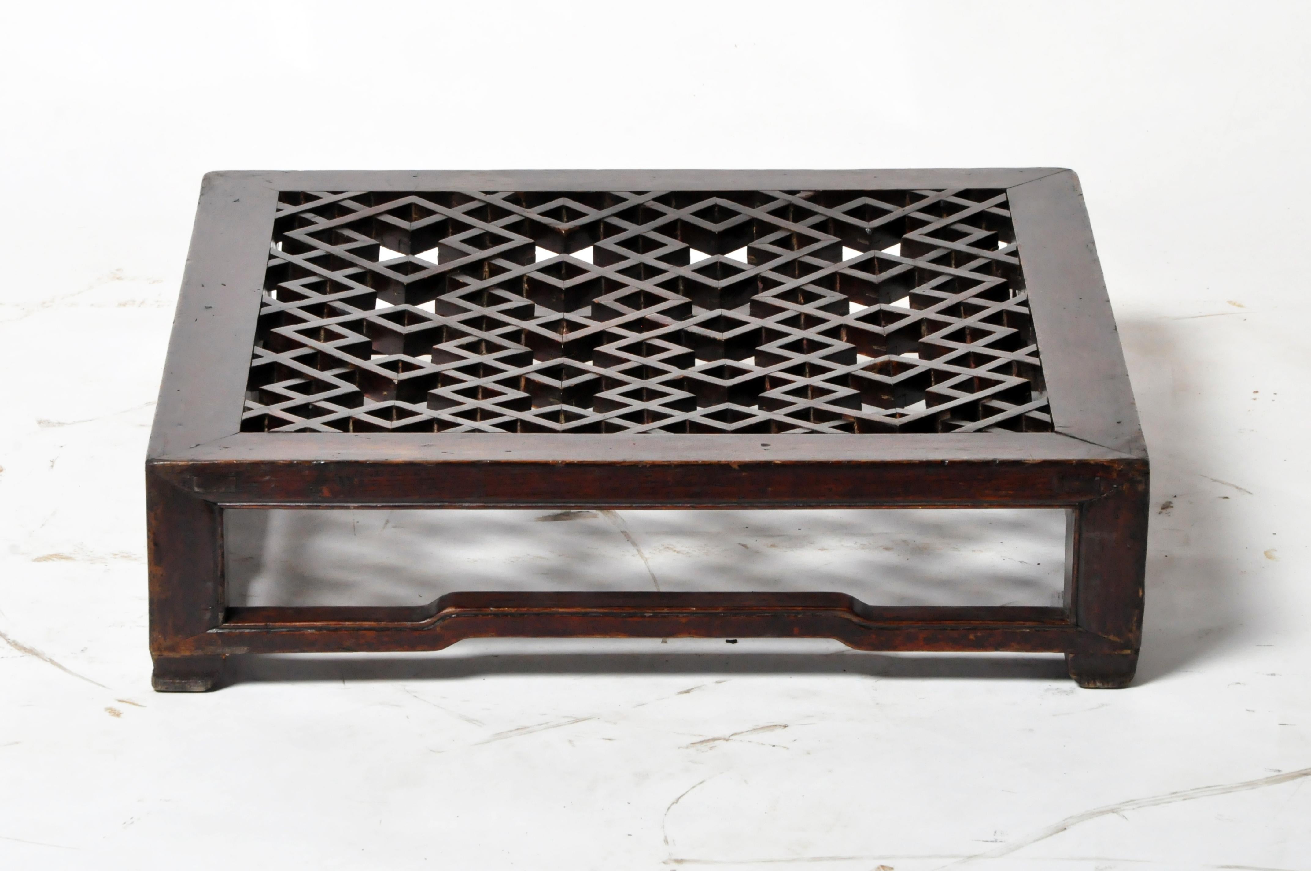 This low latticed footstool was placed in front of a chair to keep one’s feet off the cold floor. It is made from Elm Wood, came from Shanxi Province, and dates to the 19th Century. It features intricate, nail-less joinery and retains its original