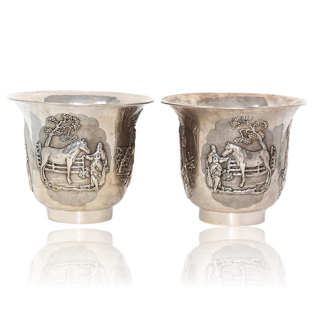 Exceptional opposing pair of rare Chinese silver wine coolers. The pair formed with tapered bodies and wide trumpet mouths sat upon a thin circular base. The central band boldly decorated with four separate scenes of important Chinese historical