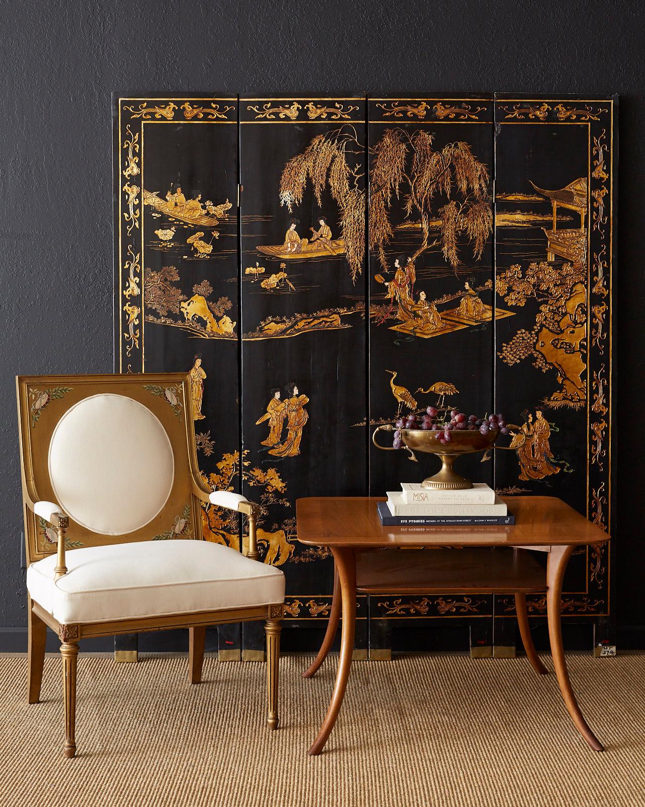 Stunning Chinese export four-panel coromandel screen featuring a black lacquer and gilt finish. The front of the screen depicts elites in an idyllic gilt landscape with trees, boats, and pagodas. The reverse side features Japanese red crowned cranes