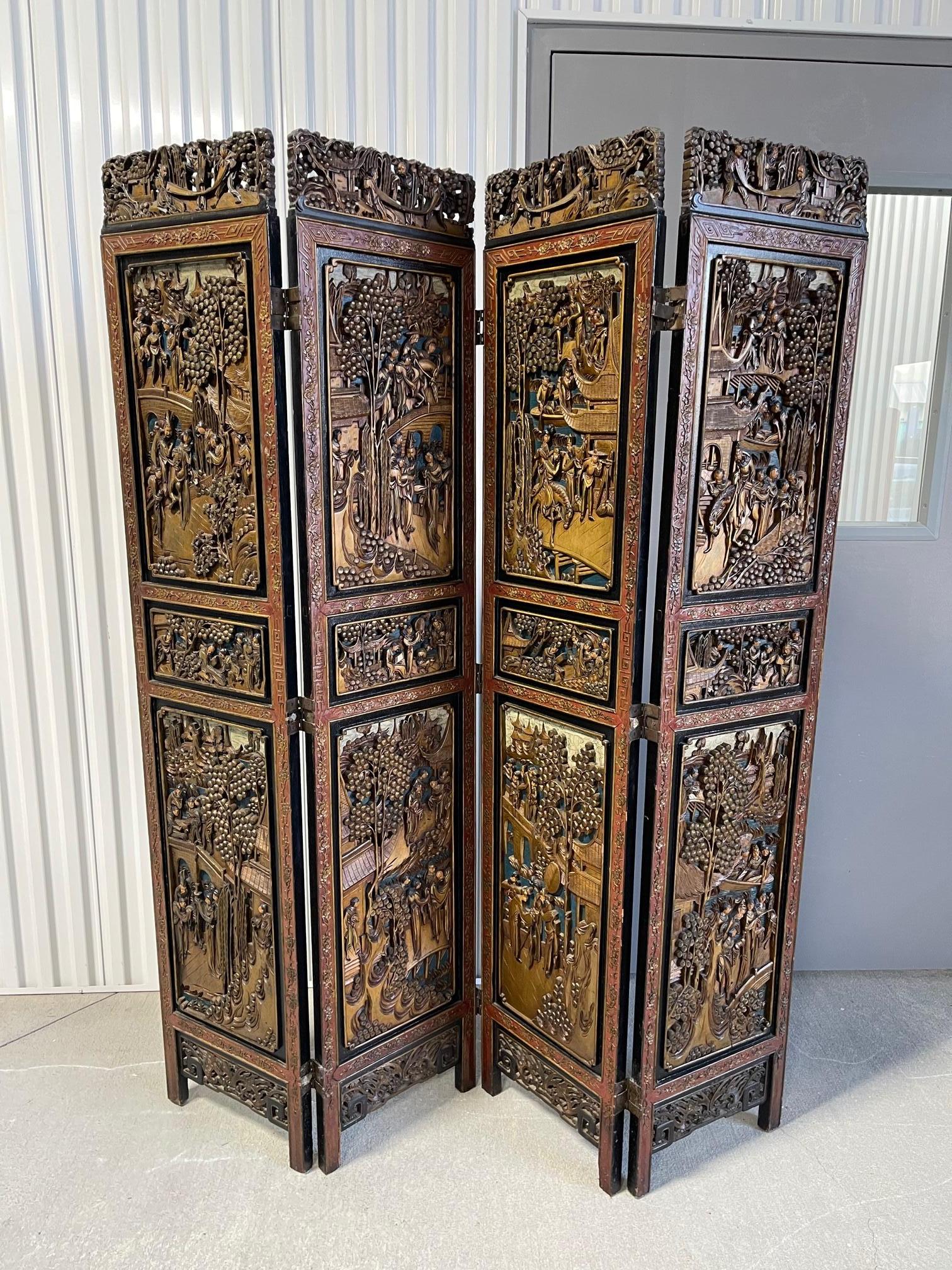 Chinese four panel hand carved folding screen, early 20th century. Figural and landscape scenes.