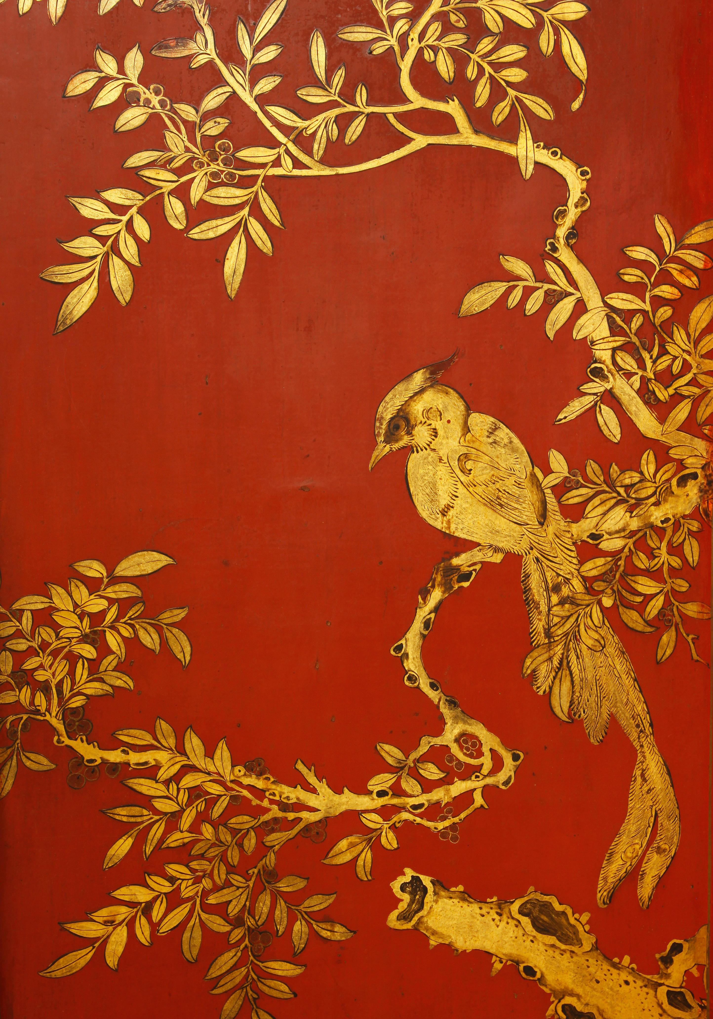 Chinese four panel screen in gilt and red lacquer features a bird on branch design. Each panel is beautifully painted within three inset areas.