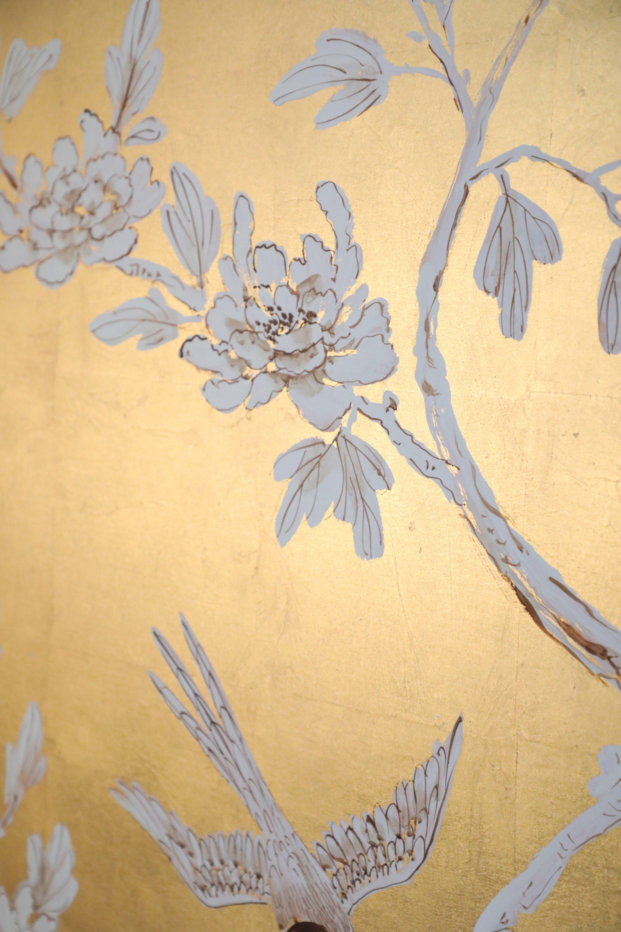 Mid-century Chinese acrylic still life painting in white, brown and beige on a gold leaf background depicting a flowering tree growing from a rocky base with a bird and dragon fly alighting on the branches in a rectangular black painted wooden