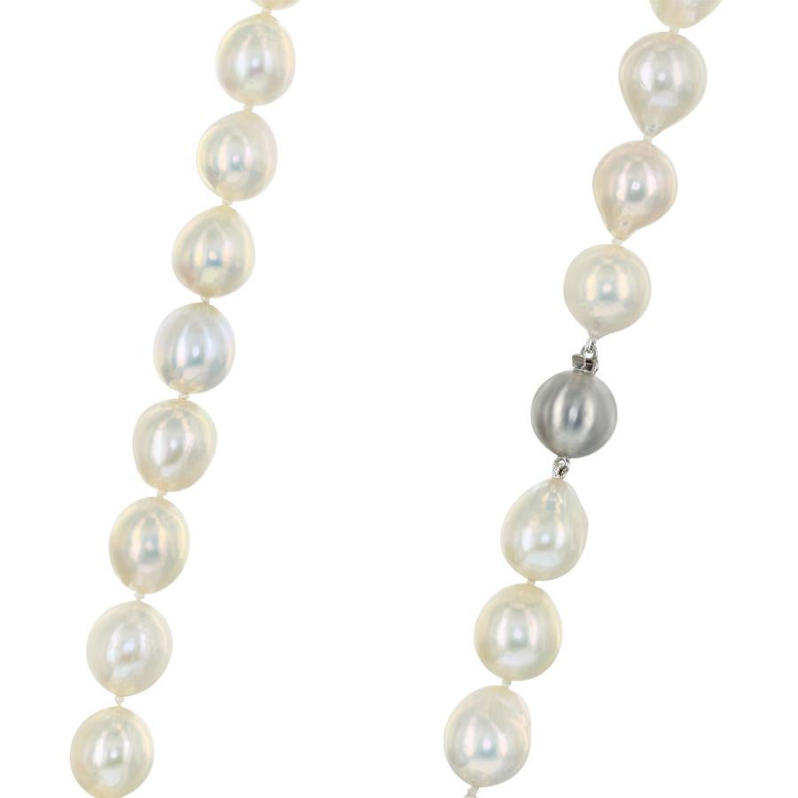 This opera length necklace features Chinese Freshwater cultured baroque pearls in a warm cream color. The pearls are 13-14mm and the necklace is finished with a sterling silver ball clasp measuring 13mm. 