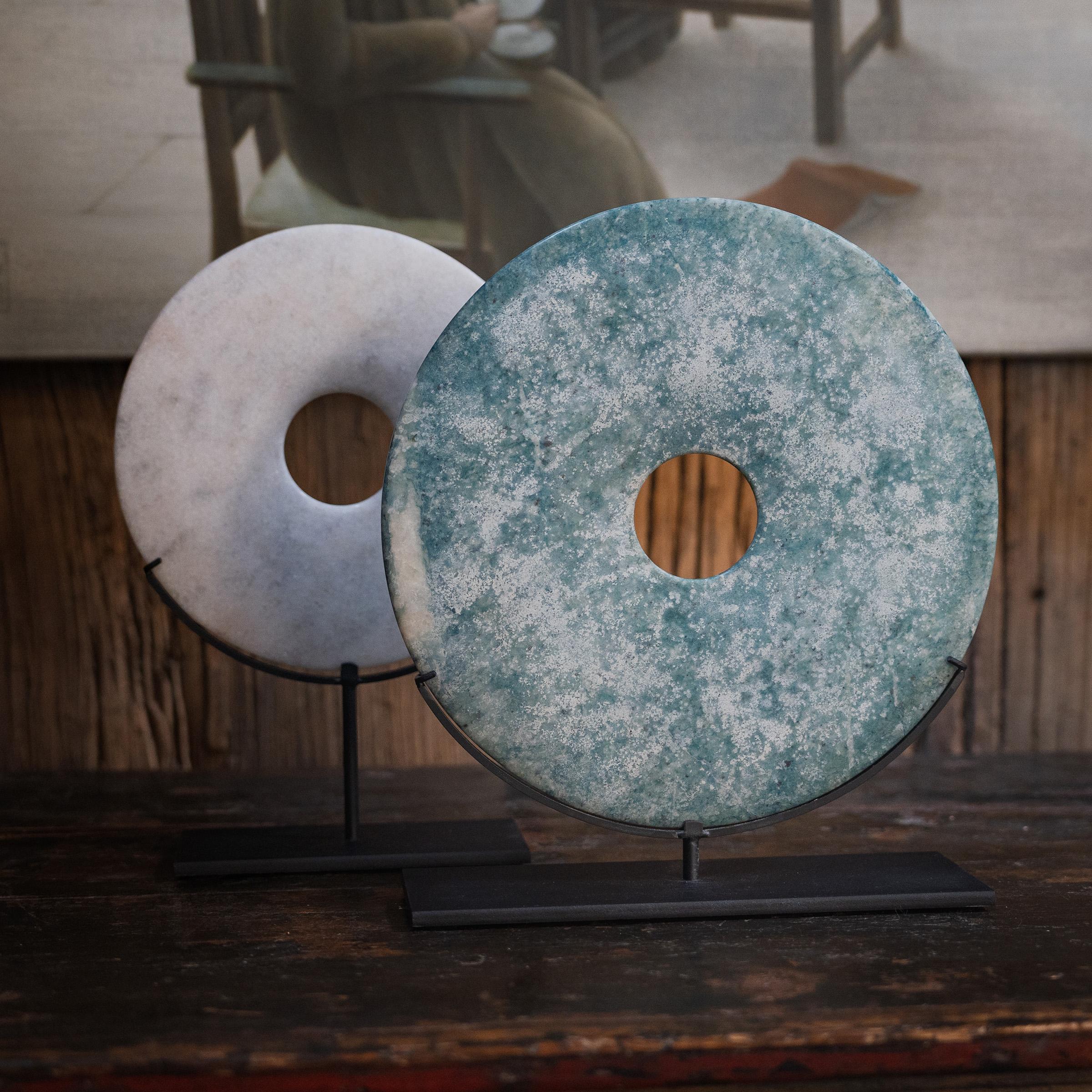 With its speckled white color and perfectly round form, this marble bi disc has a certain celestial quality, like a full moon gleaming in the night sky. Found in the tombs of ancient Chinese emperors and aristocrats, bi discs such as this have a