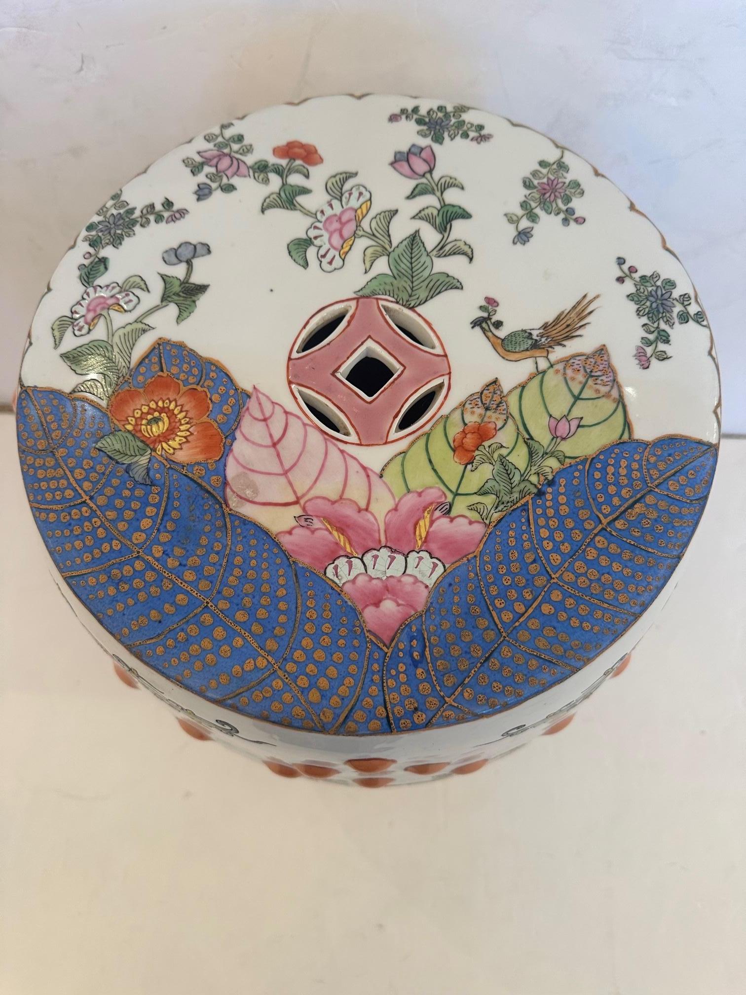 One of the prettiest Chinese garden seats ever with flowers, birds and tobacco leaves makes a lovely end table with 11.75 diameter top.   The color palette of pinks, purple, orange, green and white are utterly sublime.