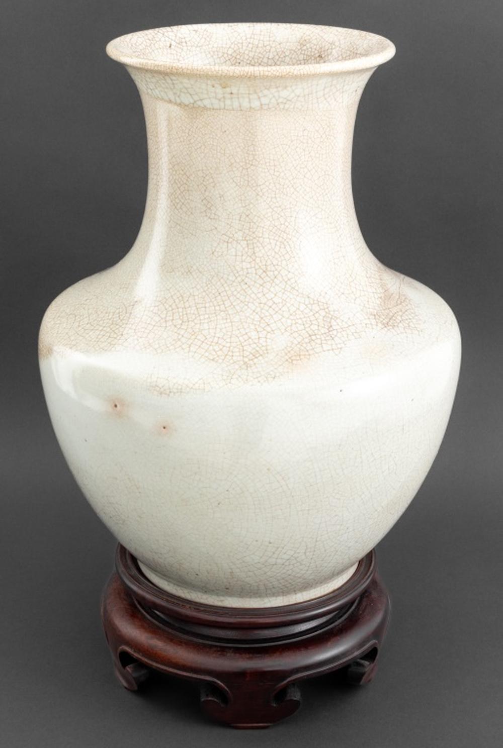 Chinese Ge Ware Type Porcelain Begonia Shape Vase, together with carved hardwood stand on four ruyi-form feet. Vase: 17.5