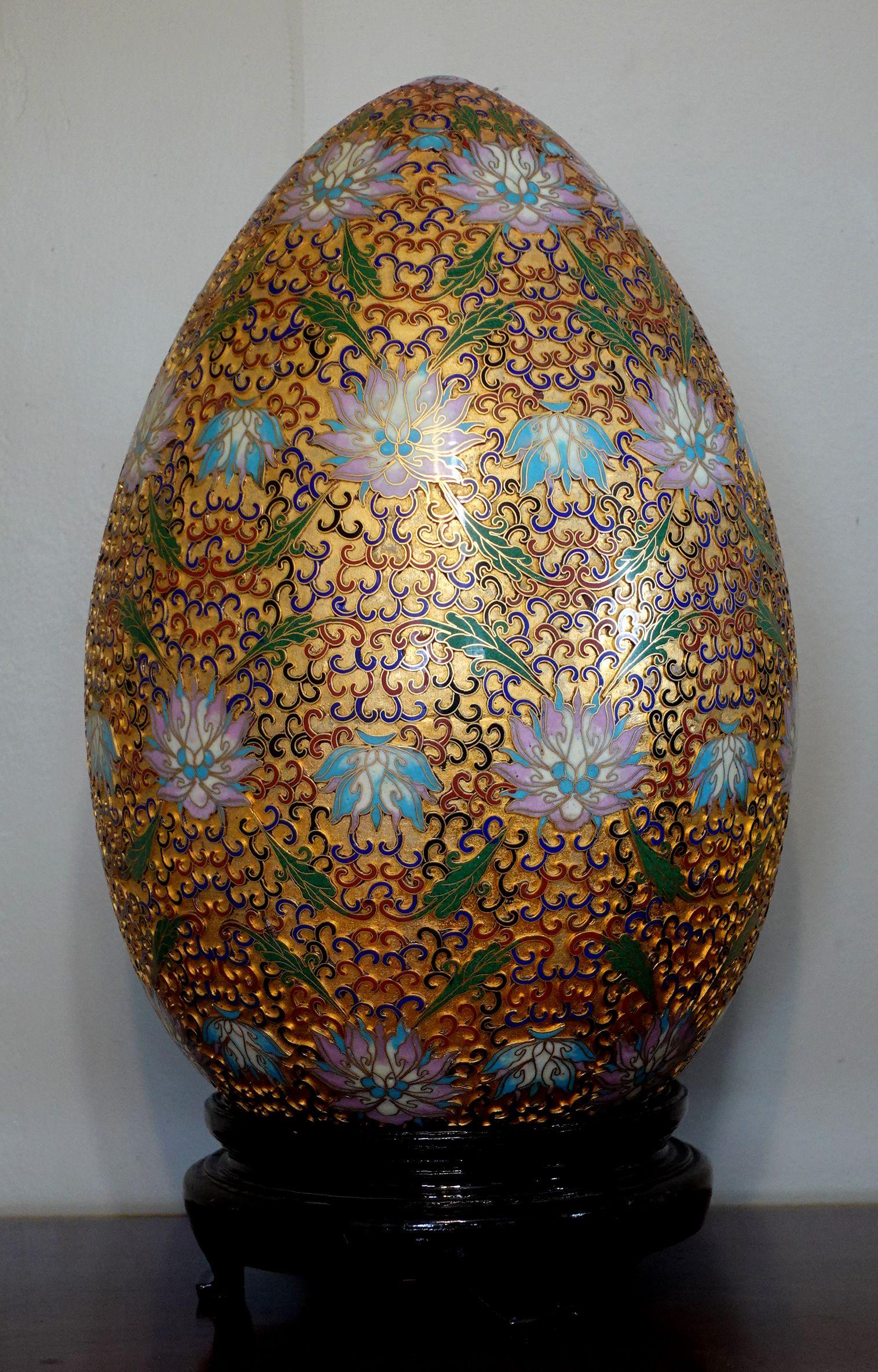 Presenting a very large and beautiful Chinese cloisonné enamel egg with intricated patterns made by hand seating on a wood stand, early 20 century. It's measured about 17