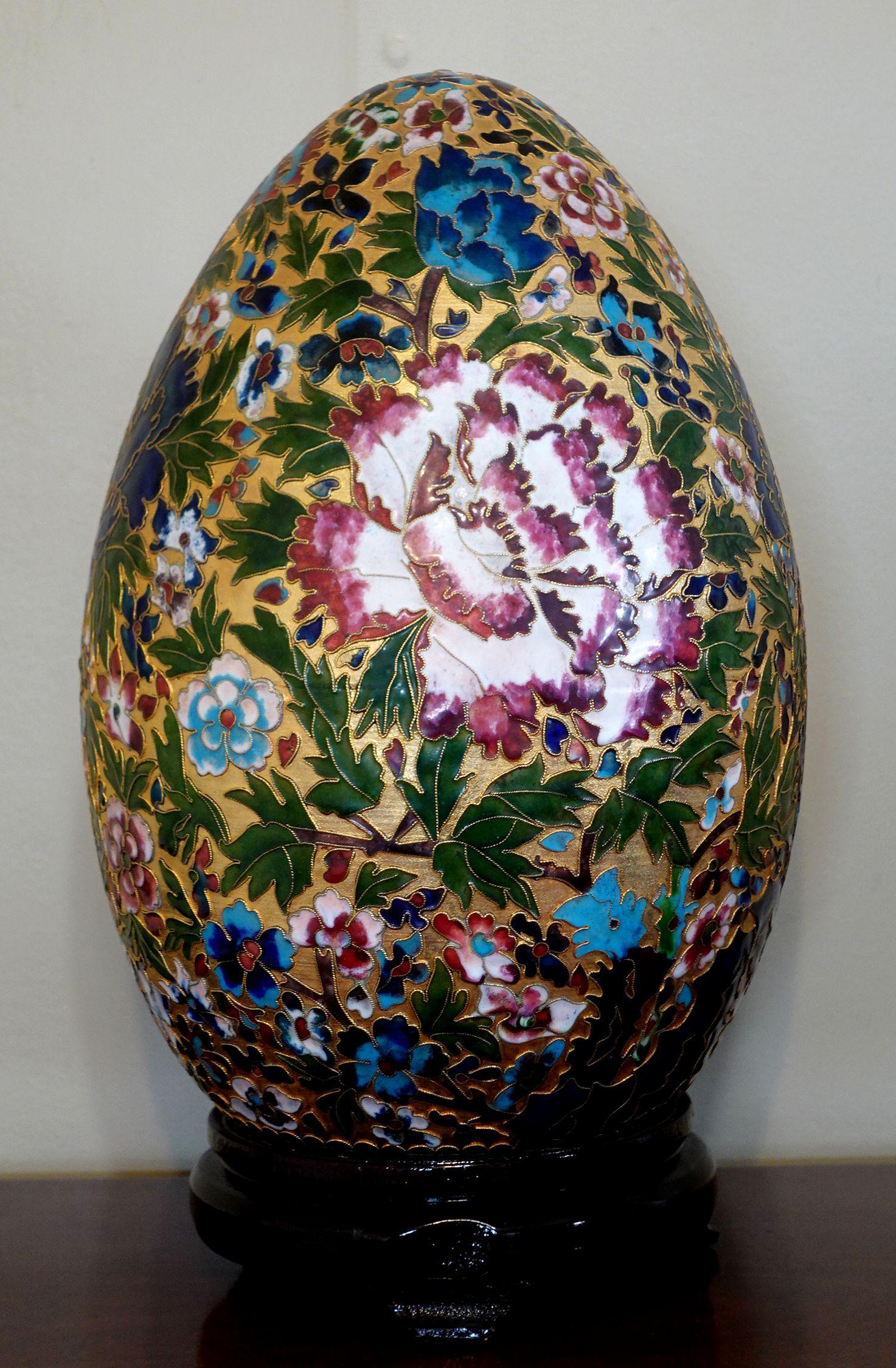 Presenting a very large and beautiful Chinese cloisonné enamel egg with intricated patterns made by hand seating on a wood stand, early 20 century. It's measured about 16.5