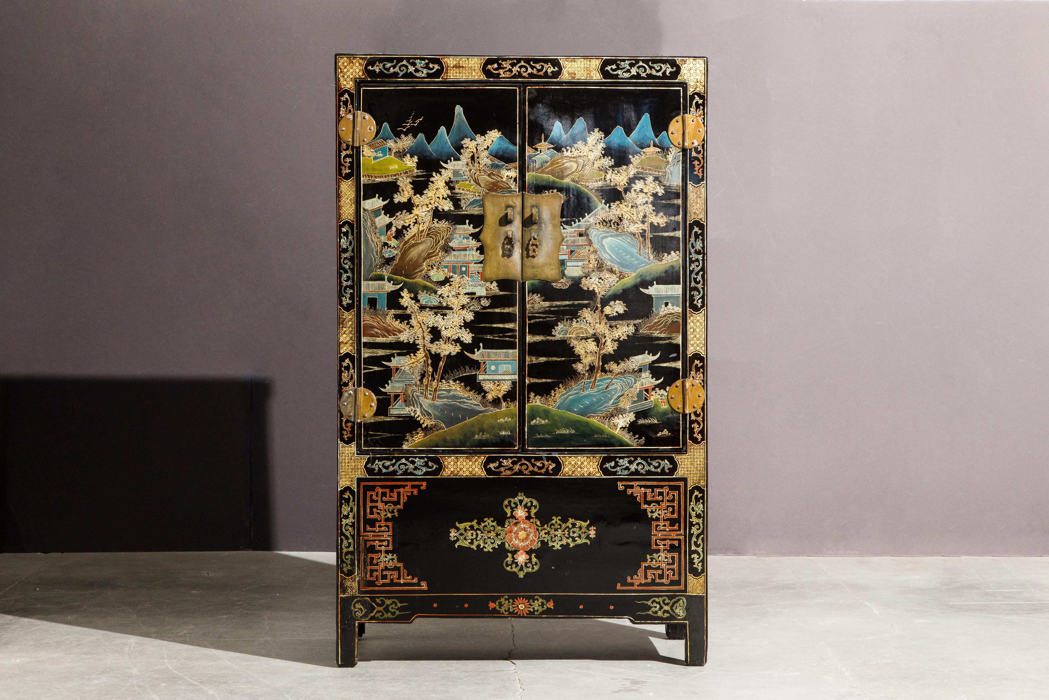 An exquisite antique 19th century Qing Dynasty gilt and black lacquered painted cabinet with double-doors, freshly refinished with a French Polish - furthering the beauty of this piece and protecting the underlying hand painted artistry. Constructed