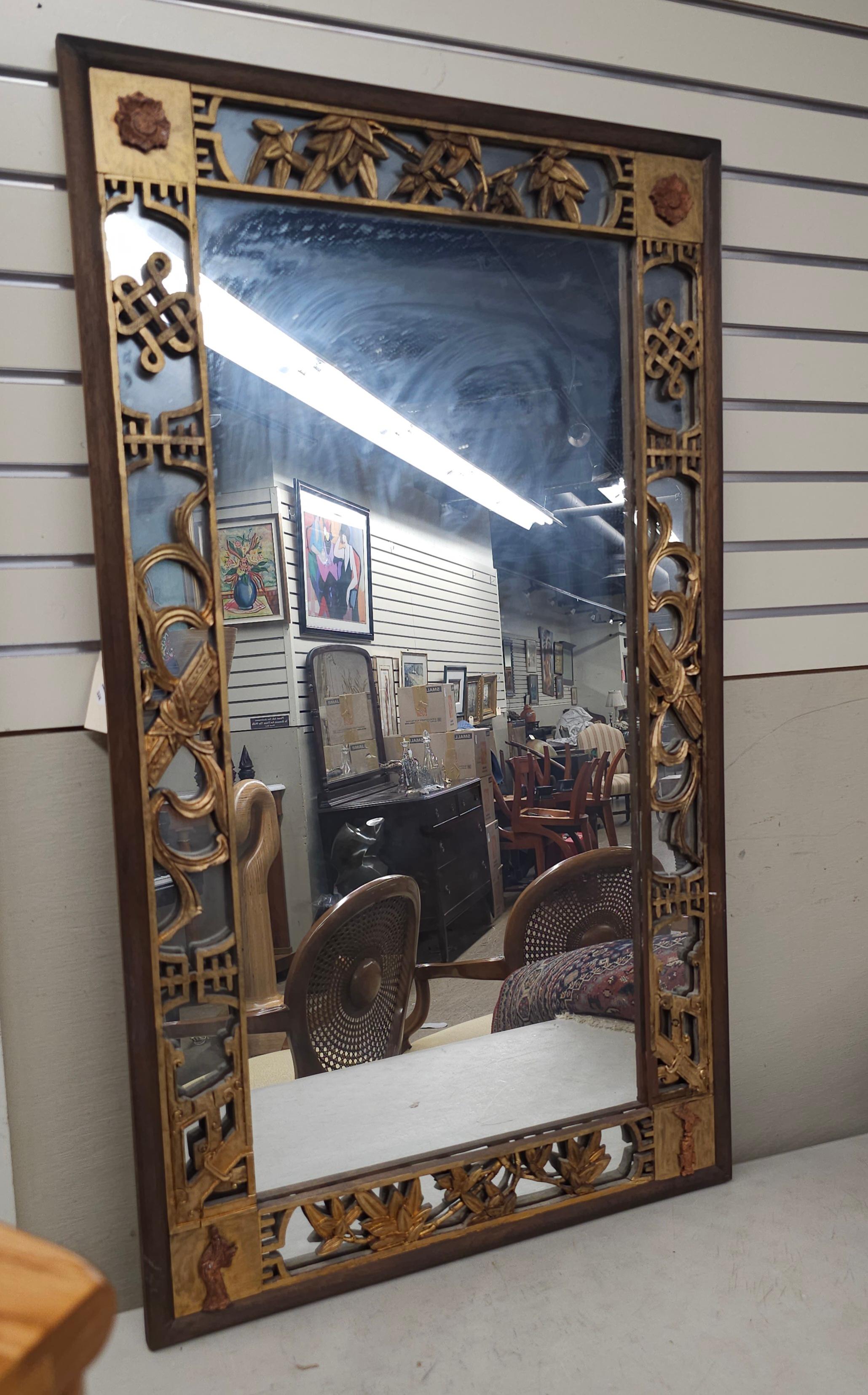 A Chinese Gilt And Rouge Lacquered, Carved and Mirrored Frame Wall Mirror with wood backing. Measures 24.75