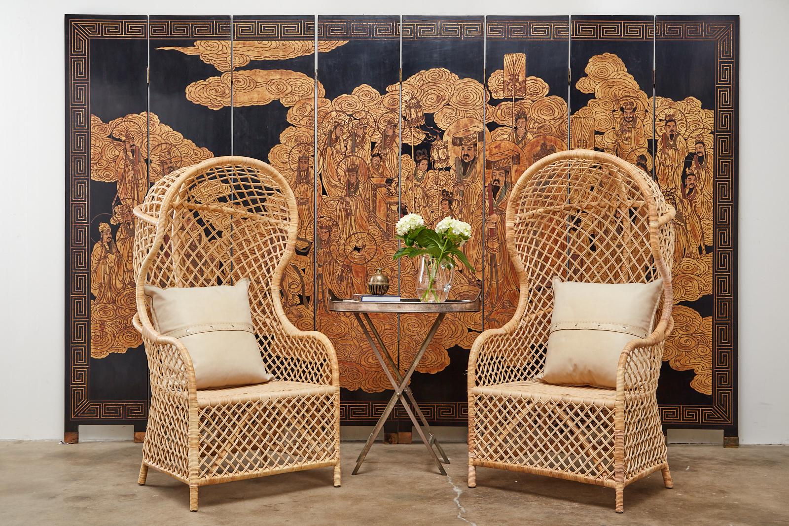 Amazing Chinese export eight-panel lacquered coromandel screen depicting a heavenly scene of immortals and sky gods floating in ruyi clouds. The fascinating scene is crafted in dramatic gold leaf and gilt with a stylish Greek key pattern border