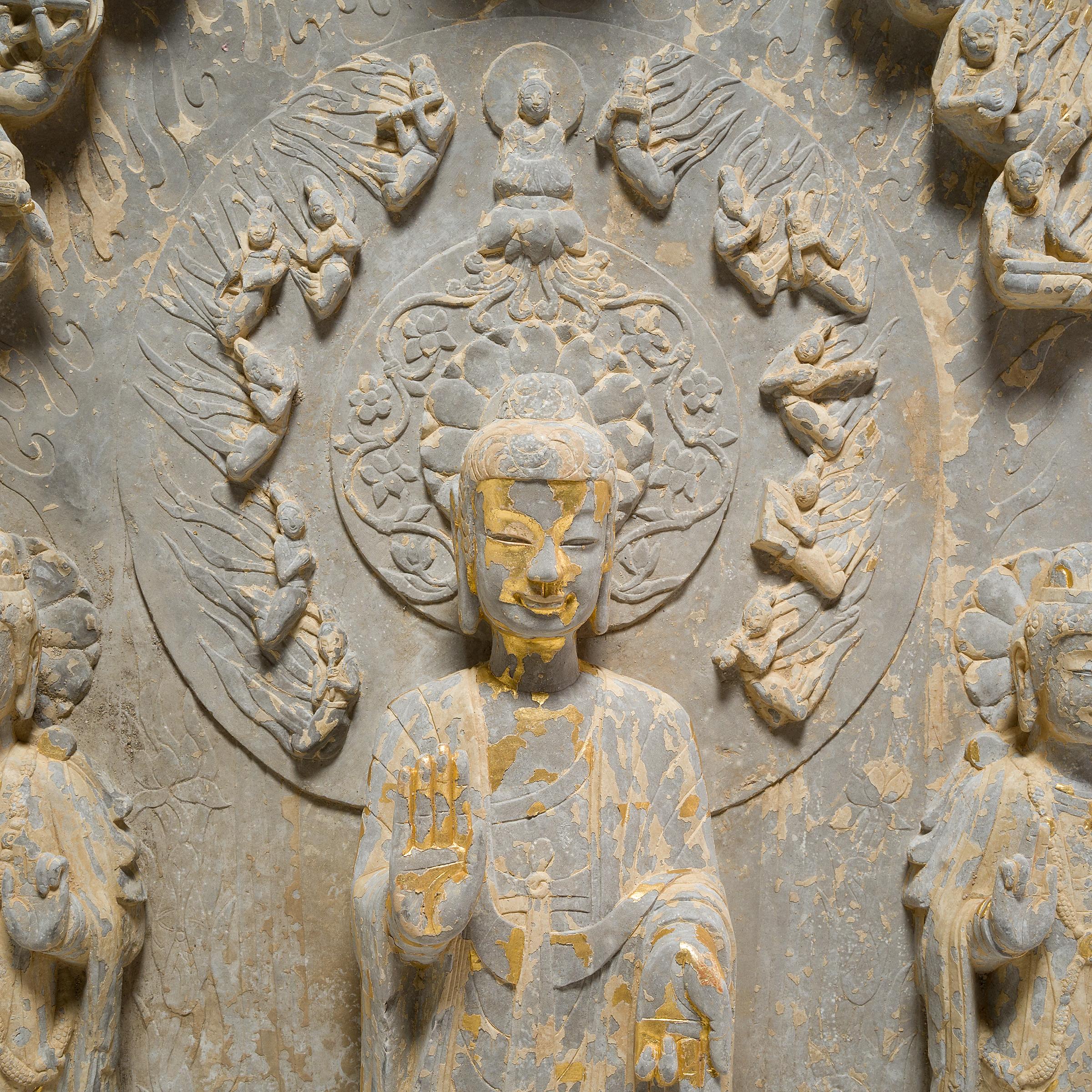 This intricate limestone stele of a standing buddha likely depicts Maitreya, the Buddha of the Future. The only Buddhist divinity revered as both a bodhisattva and a Buddha, Maitreya is prophesied to return to Earth some time in the distant future