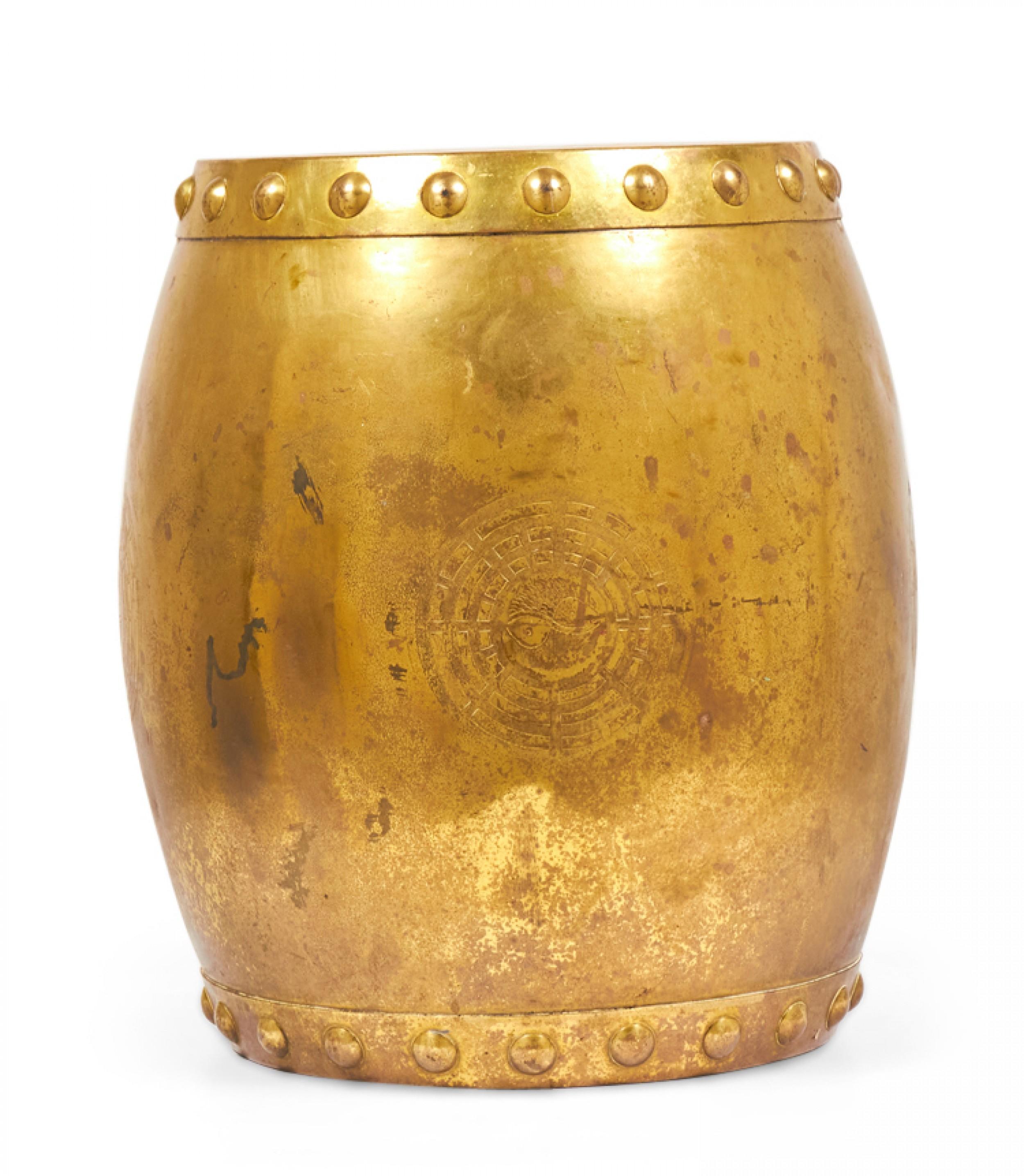 Chinese gilt metal drum-form garden seat with a band of circular studs around the top and bottom and an incised decorative yin and yang symbol.